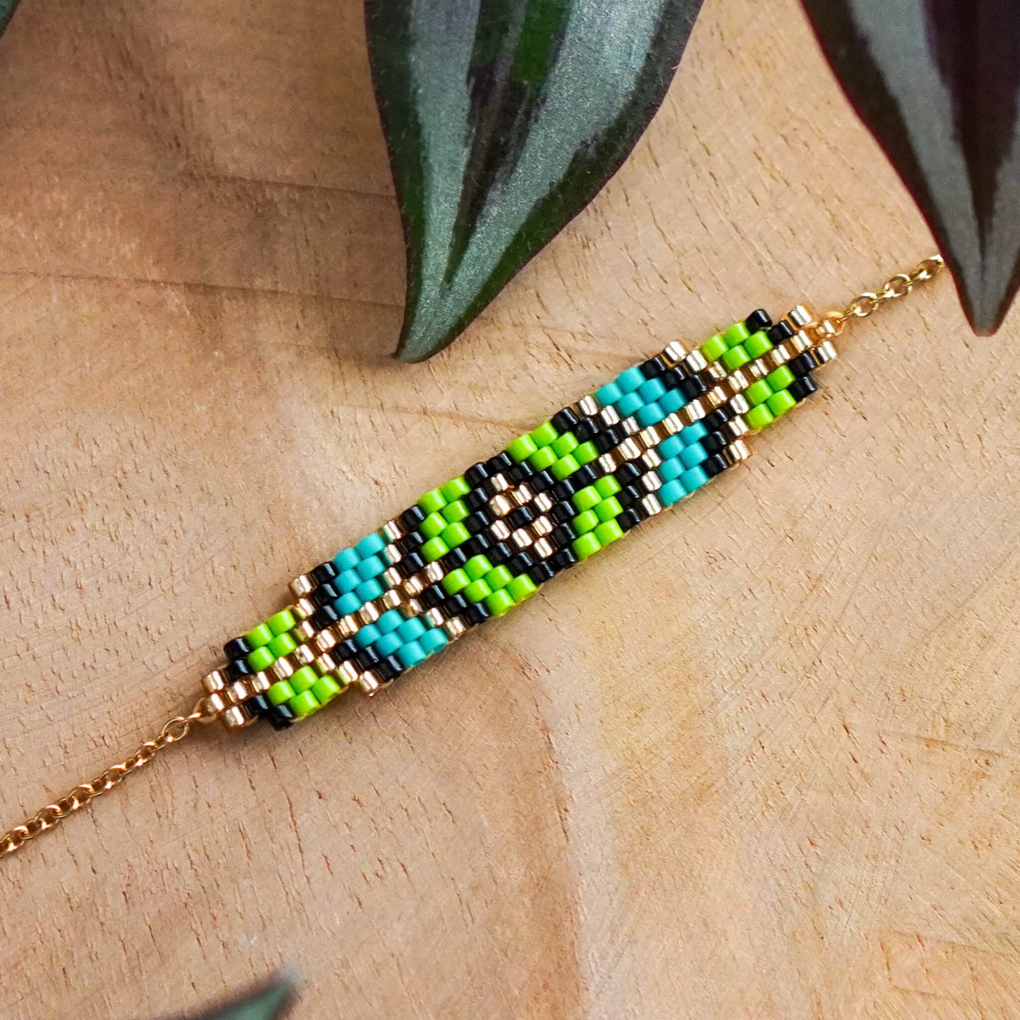 Bransoletka Prism z geometrycznym wzorem w kolorach soczystej zieleni i turkusu, wykonana z koralików szklanych na łańcuszku ze stali