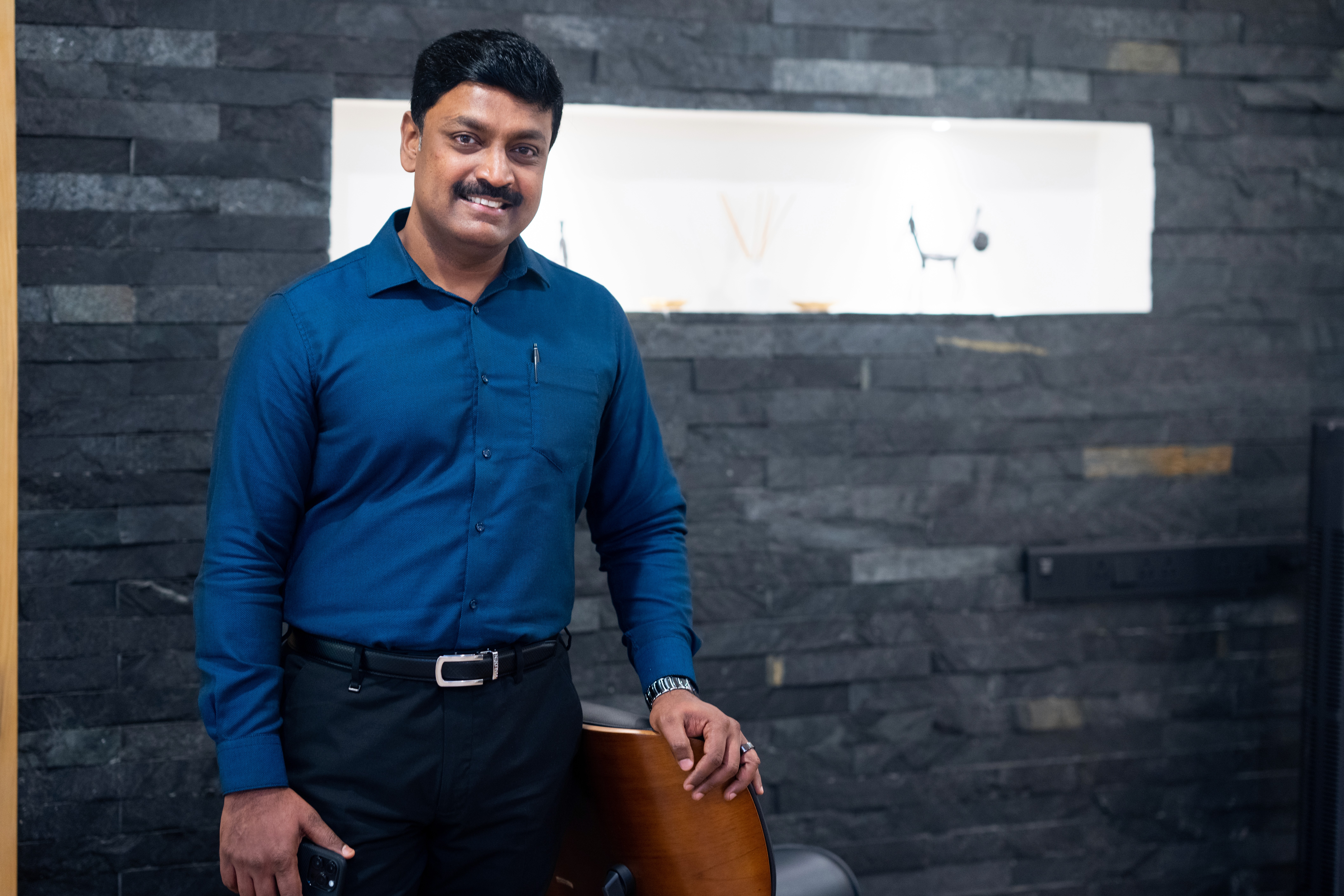 a group of people sitting at a table with computers