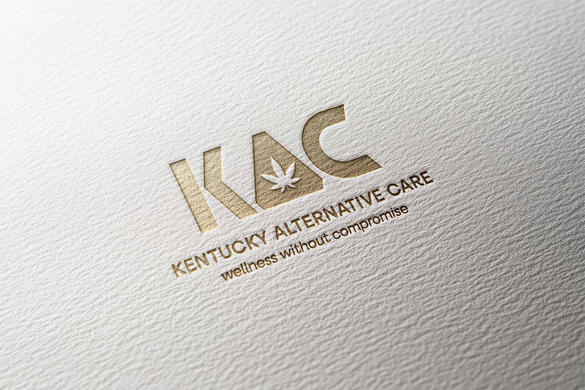 KAC Logo embossed in gold on a paper