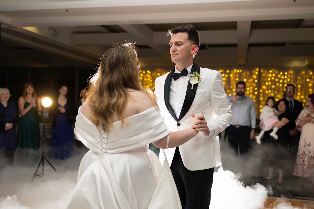 Bride and groom first dance in front of guests