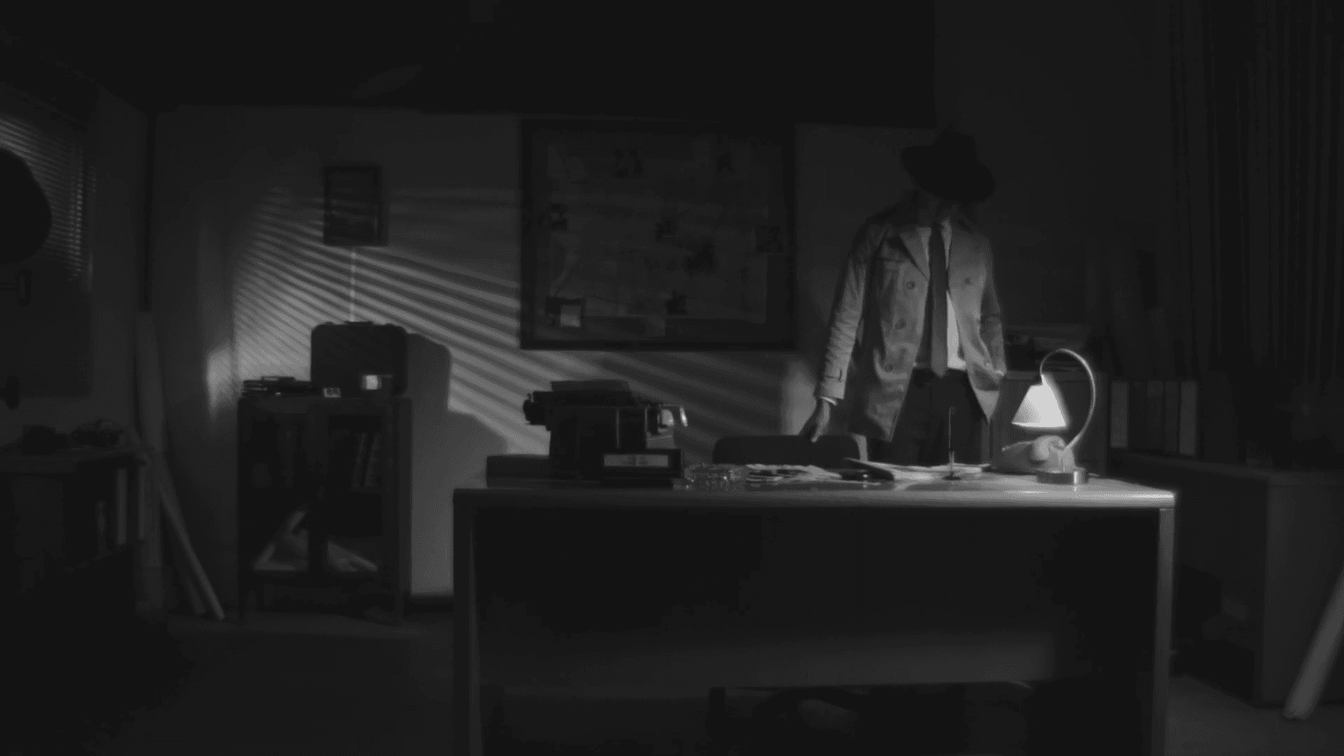 View of the French countryside through a stone villa’s open living room, with sofas and trees framing the scene
