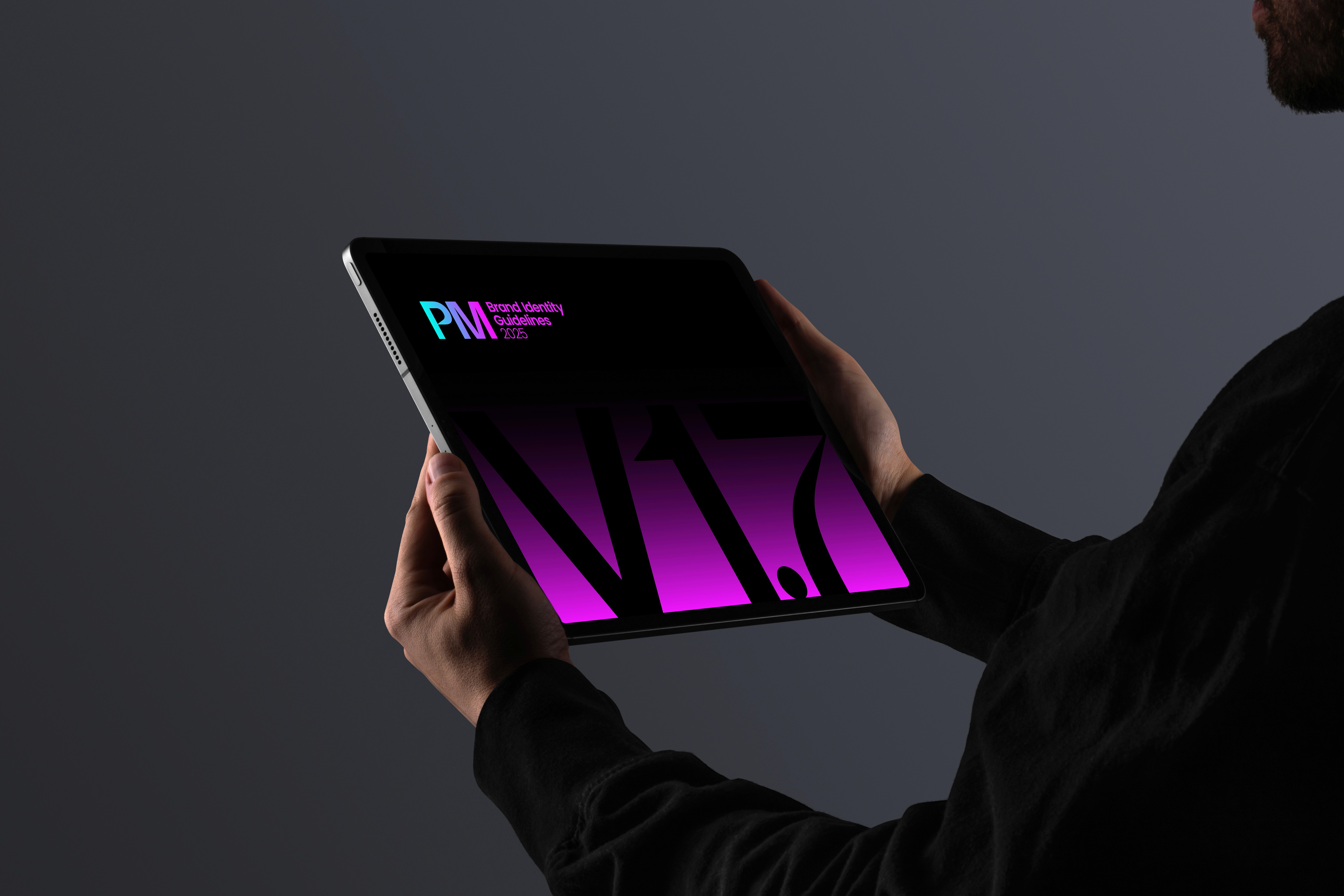 Man holing iPad showcasing Premier Miton web design concept screen.