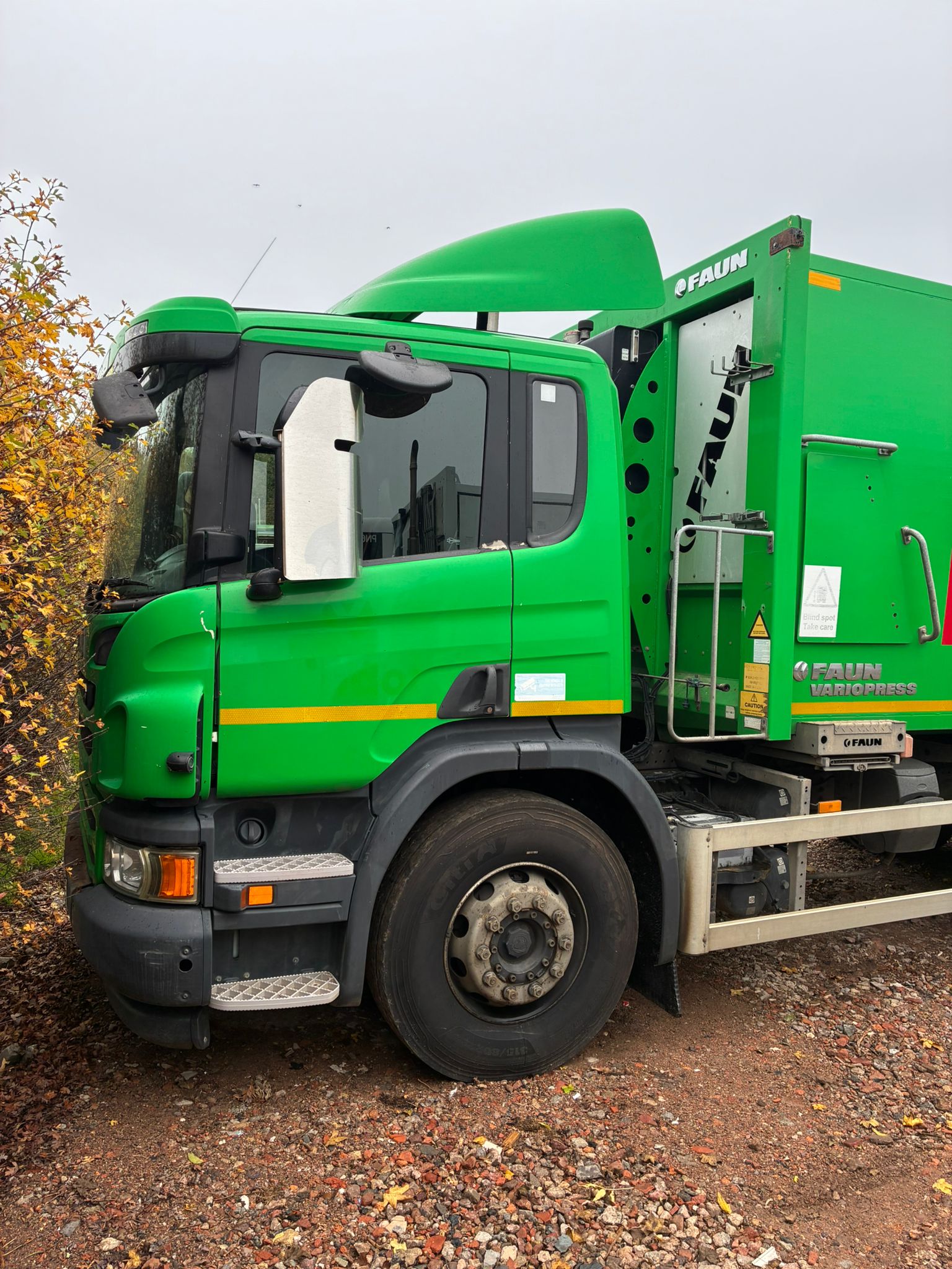 Aerial view of a winding road cutting through rocky terrain with patches of grass.