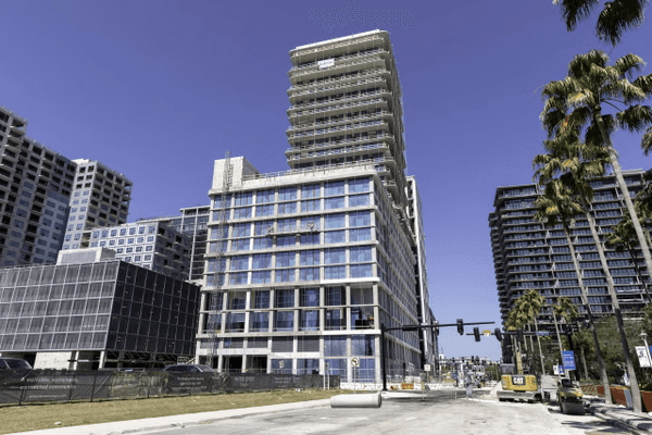 Vertical view of Water Street Tampa Phase 2 buildings showing modern mid-rise residential and commercial towers with palm trees