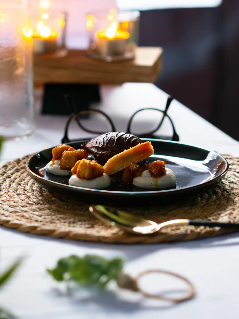 Chocolate dessert at a candlelit table on a woven placemat