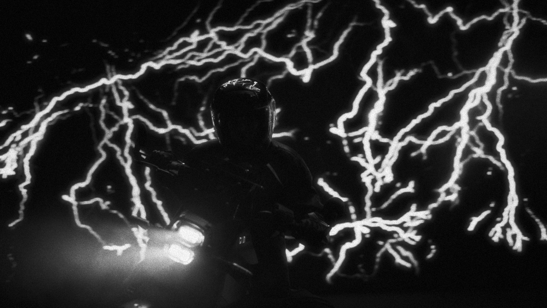 Rider silhouetted against branching electric bolts, black and white grade for Can-Am's electric motorcycle campaign