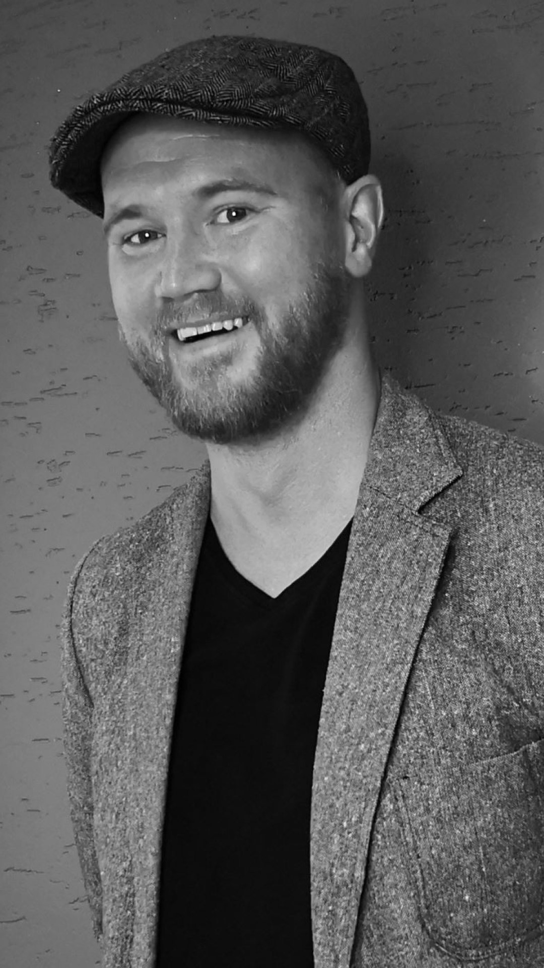 Black and white portrait of a man wearing a hat