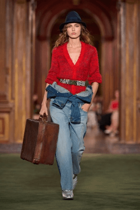 Image may contain Clothing Pants Jeans Adult Person Knitwear Sweater and Bag