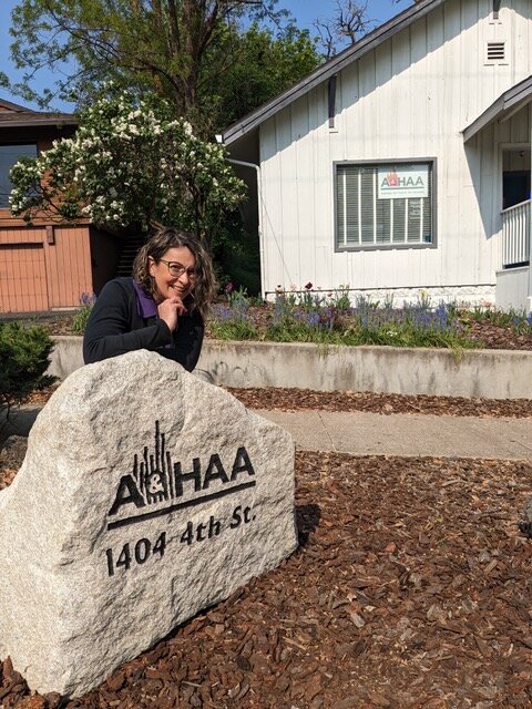 a woman is putting a pair of earplugs on her ear