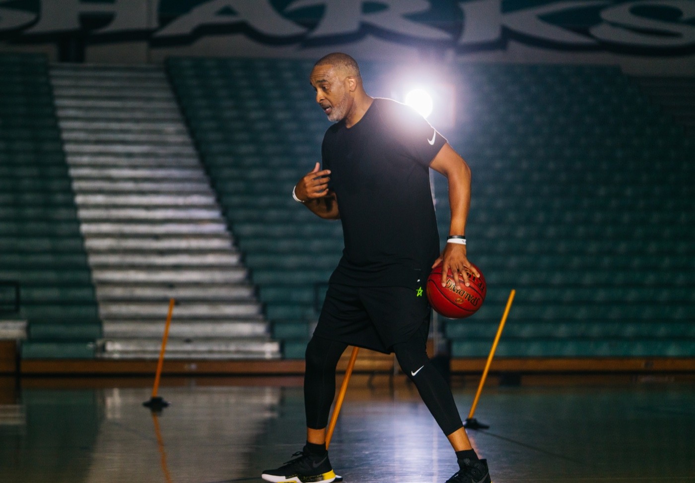 Phil Handy coaching with a basketball on court