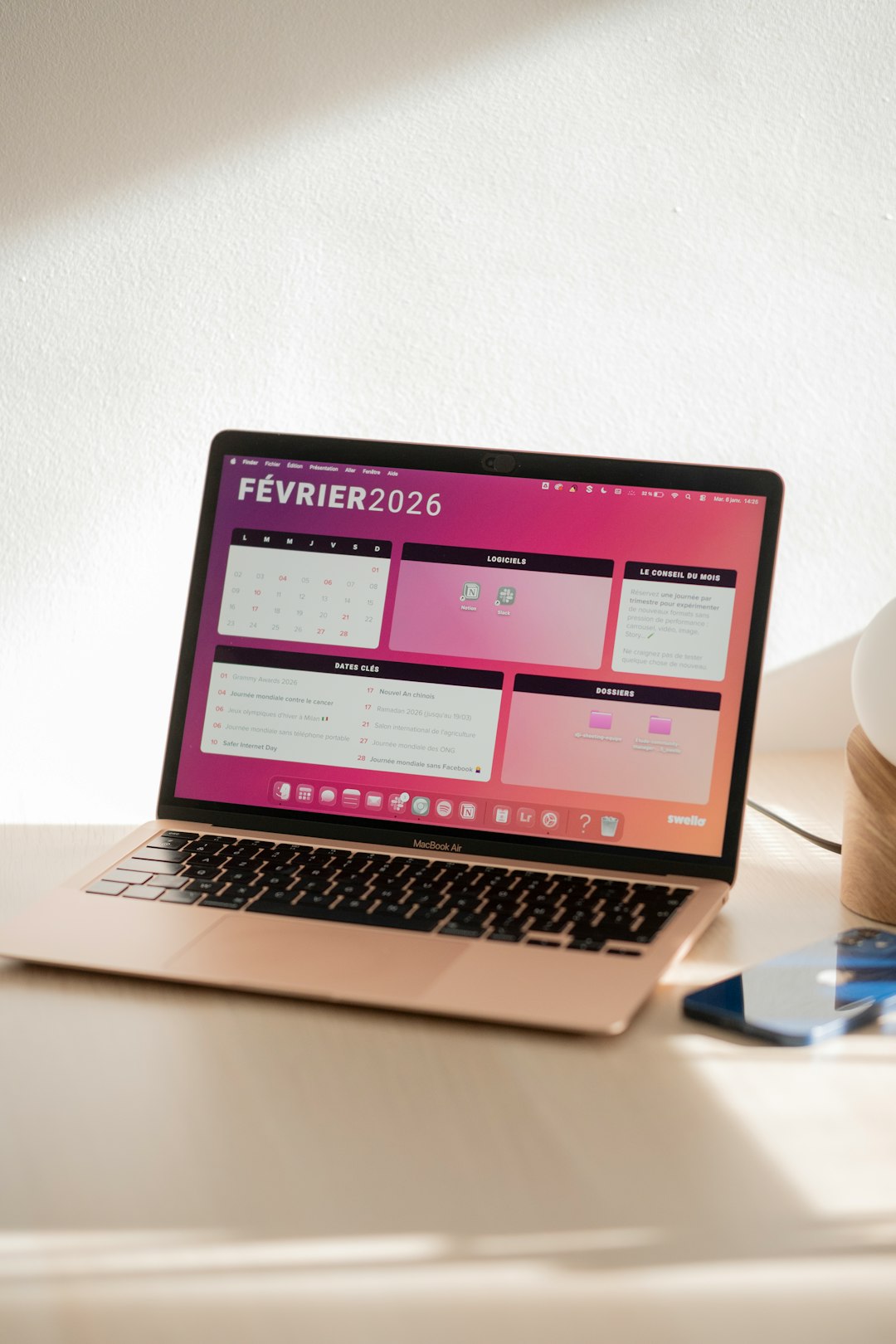 Laptop displaying a colorful february 2026 calendar.