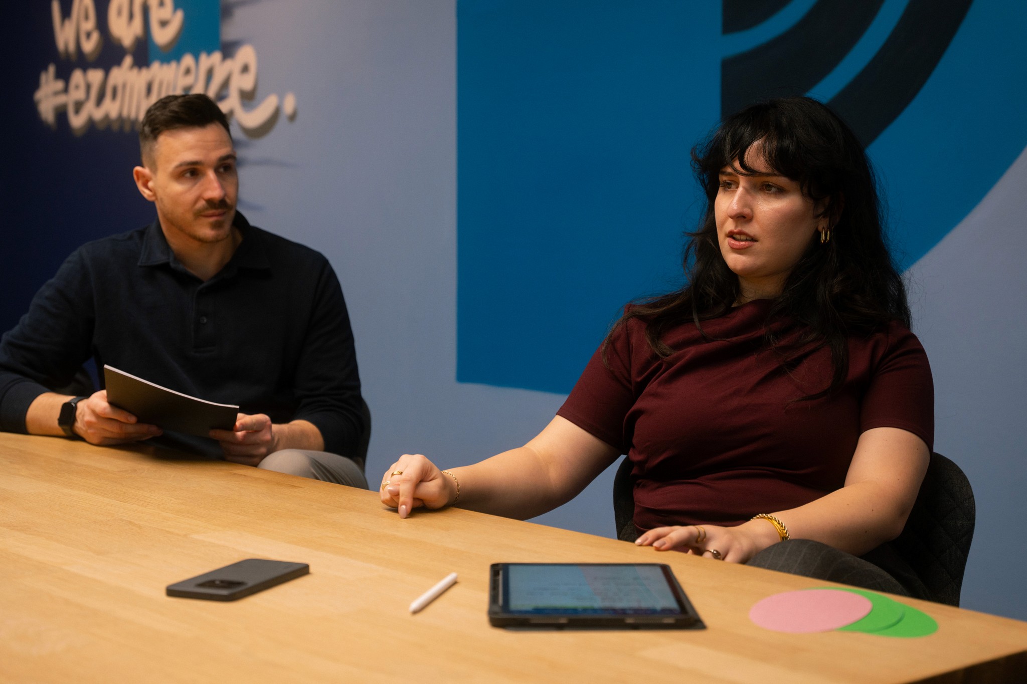 woman in blue tank top standing beside white wall