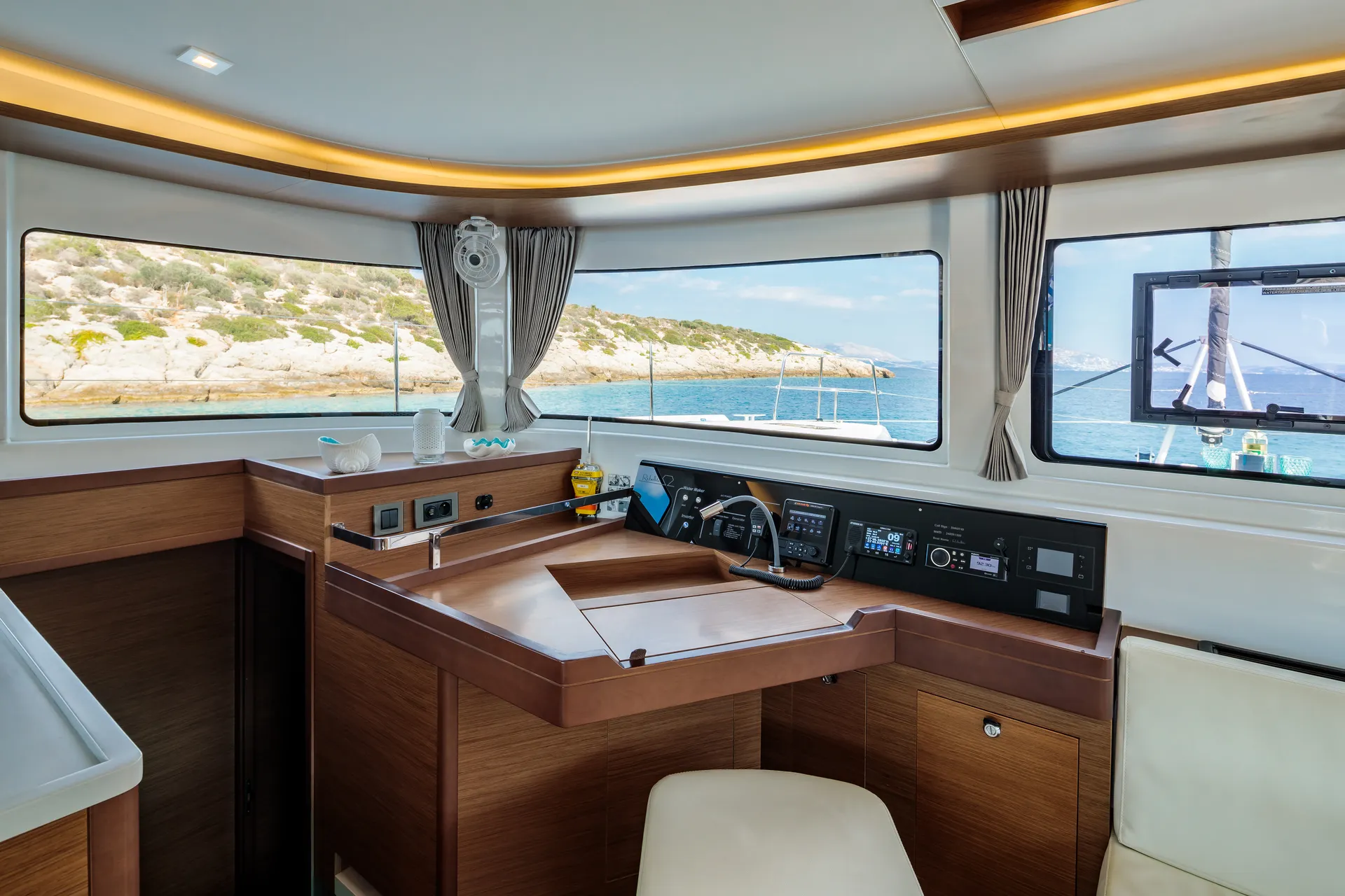 White Rock 36 speedboat with captain at helm cruising calm blue waters near Paros coastline with hills in background.