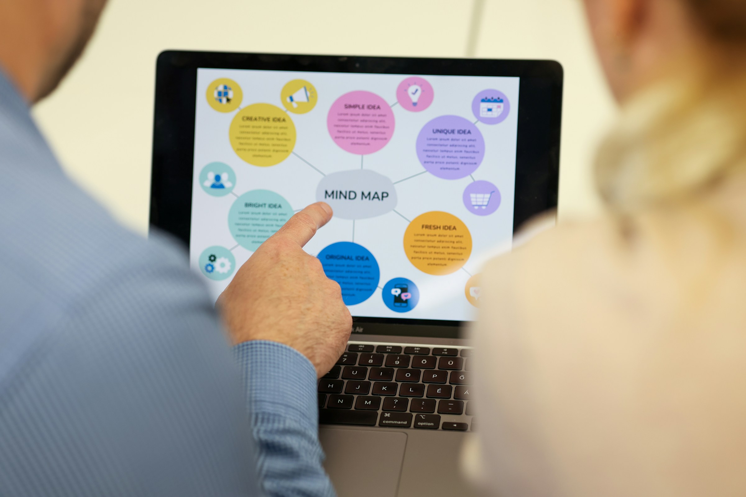 Person Pointing at Laptop - AI Automation Agency