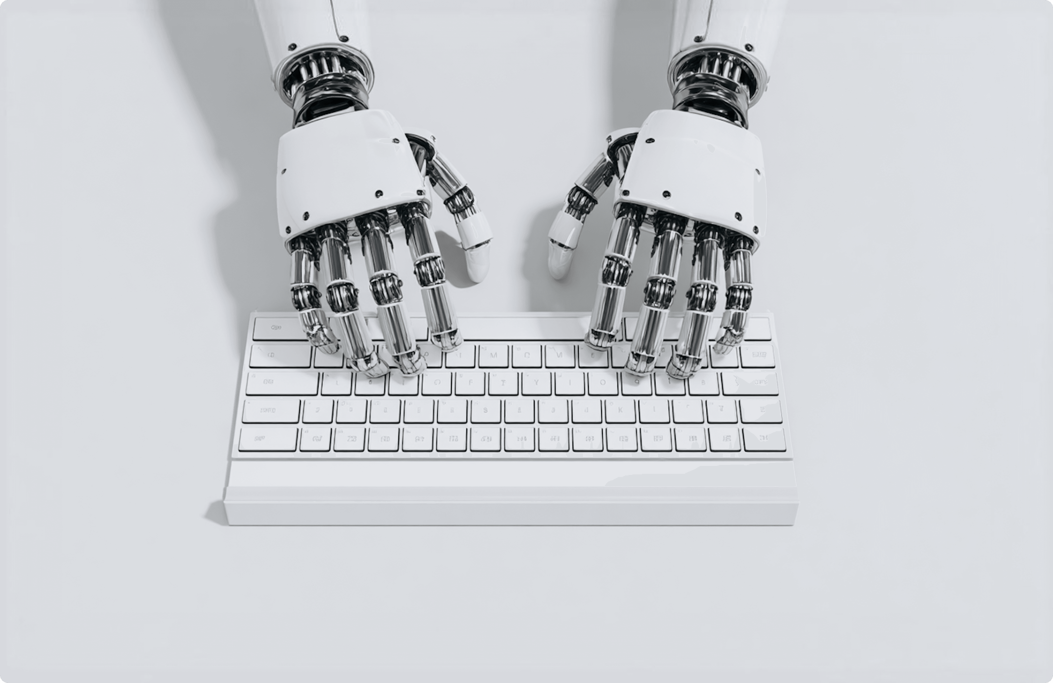 A robotic hand typing on a white keyboard.