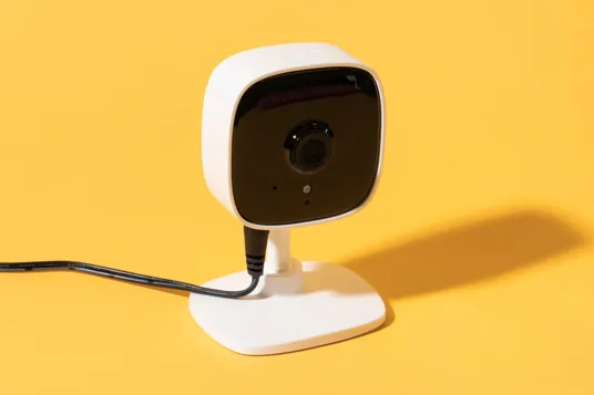 Surveillance camera and AI-powered facial recognition system monitoring a public area.