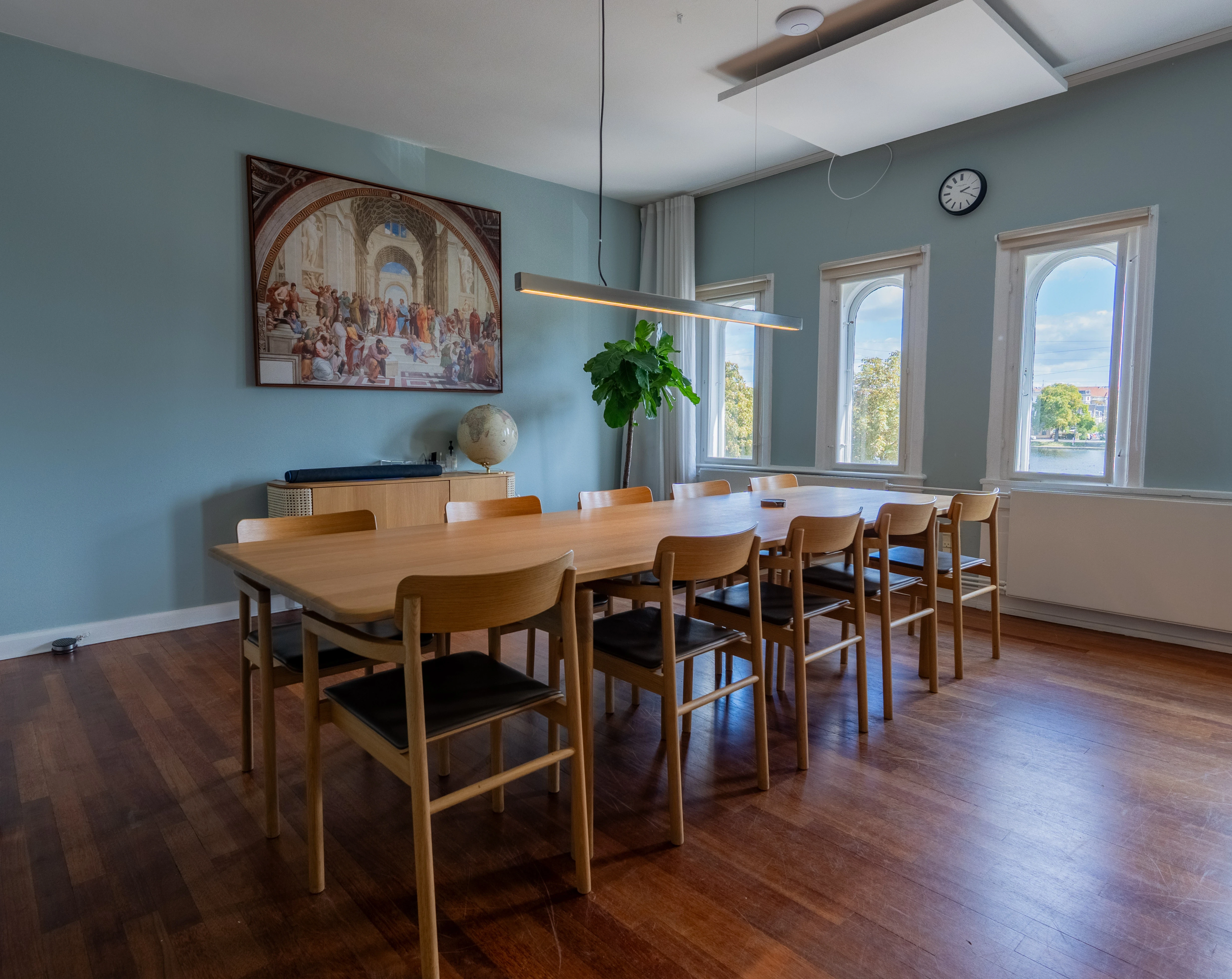 A green butterfly rests on a flower.