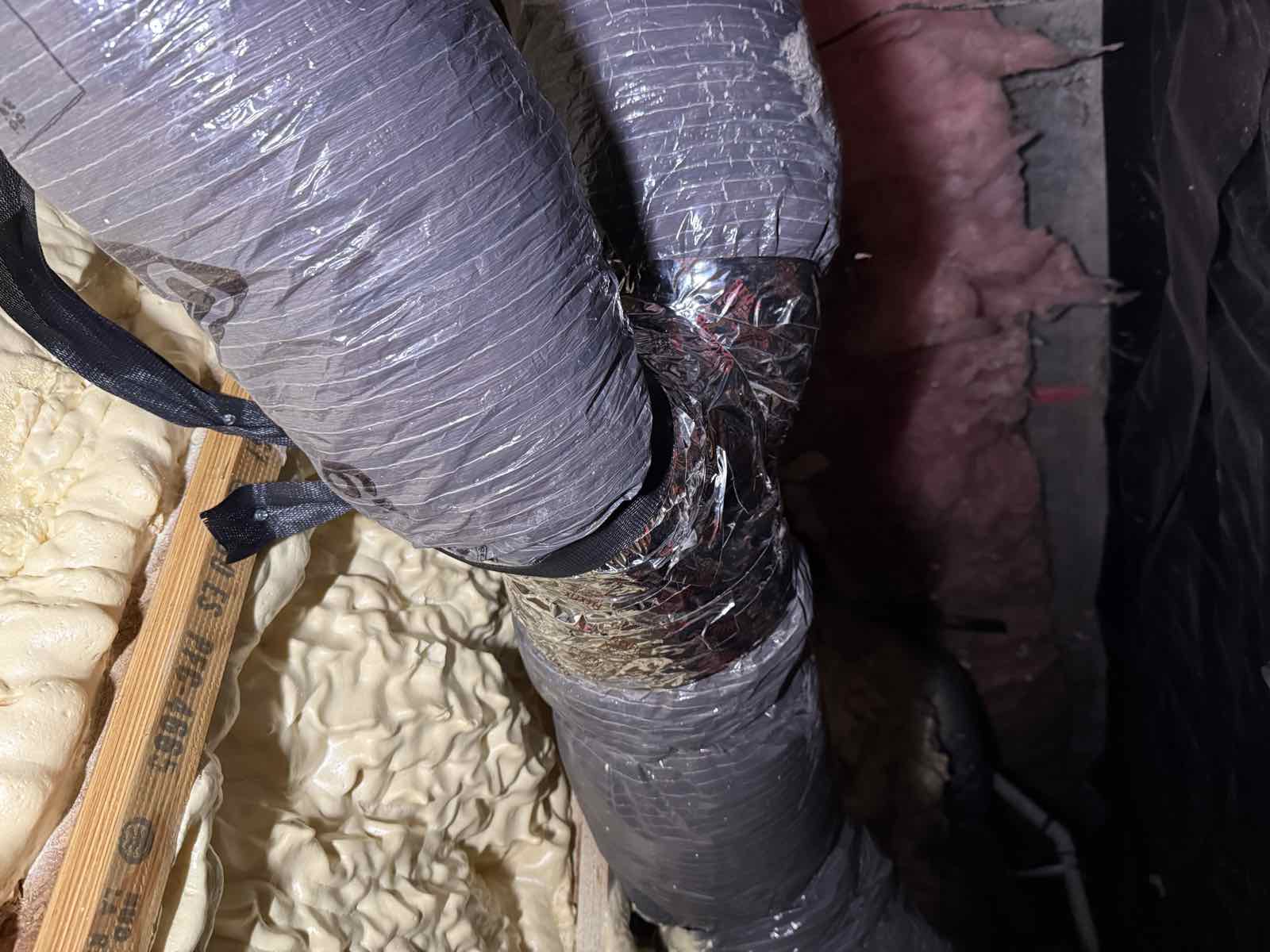 The rebuilt duct connection, sealed and strapped.