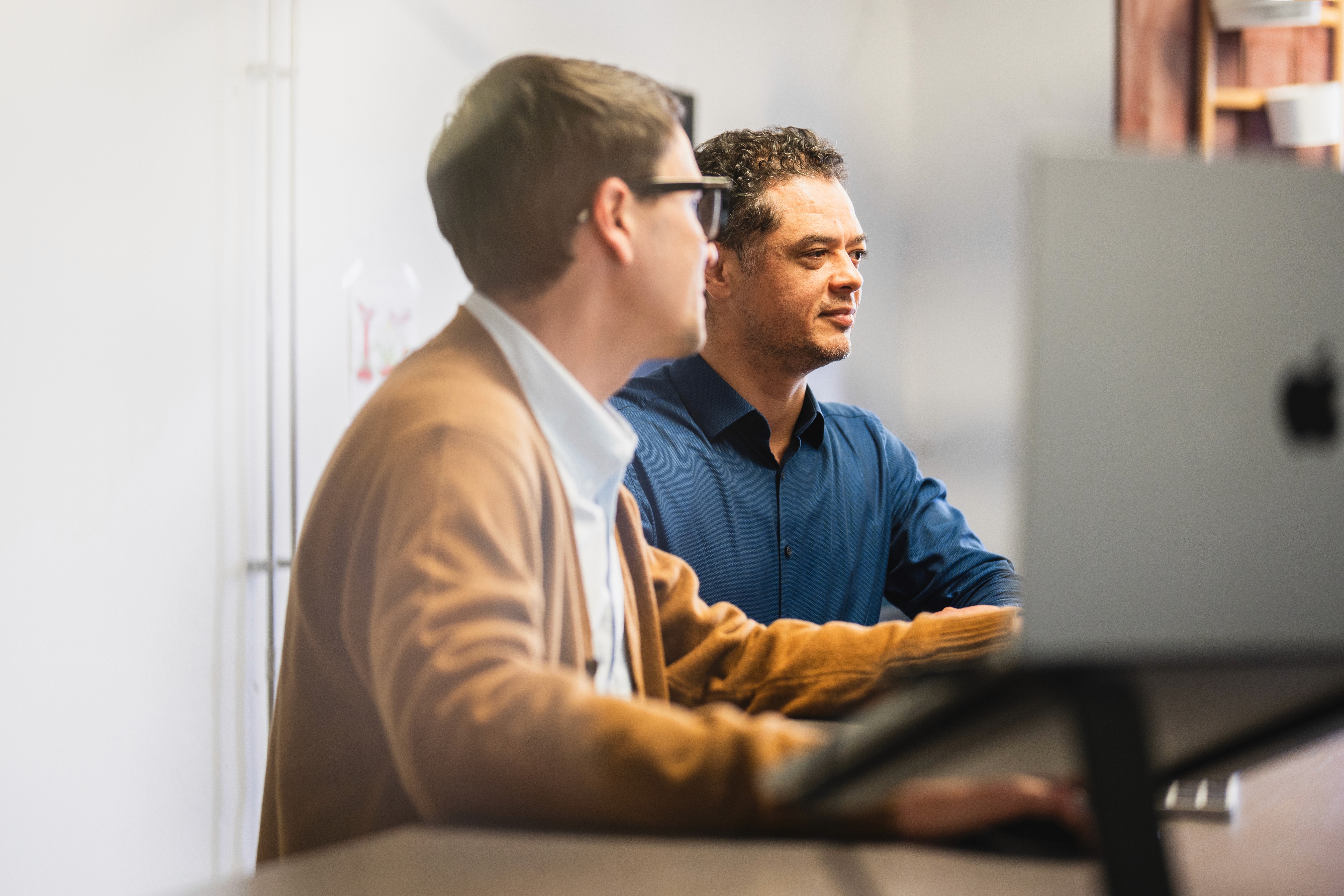 two people from Pionect looking at their desktops