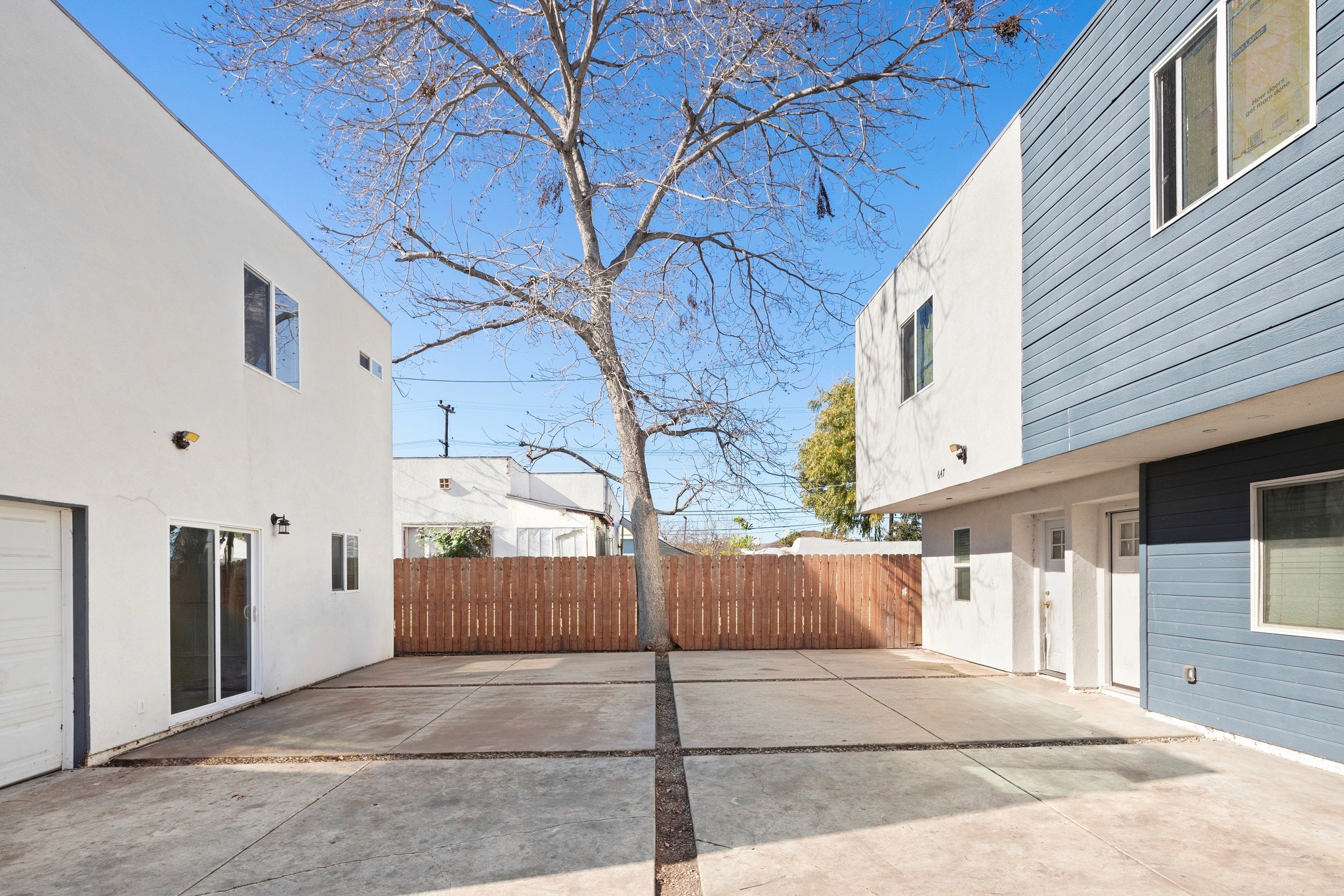 Rear exterior showing paved parking area and modern building layout at 645 west 97th street.