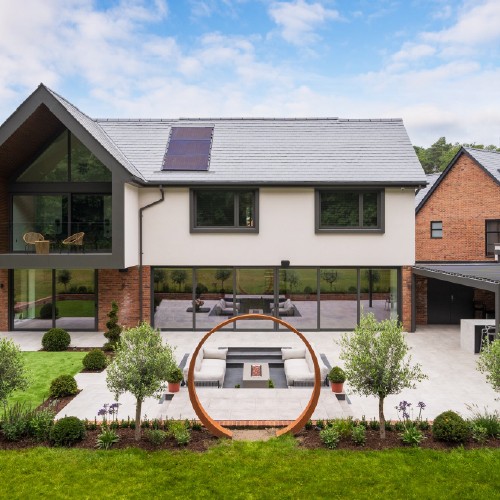 Rear exterior shot of property with lanscaped gardens