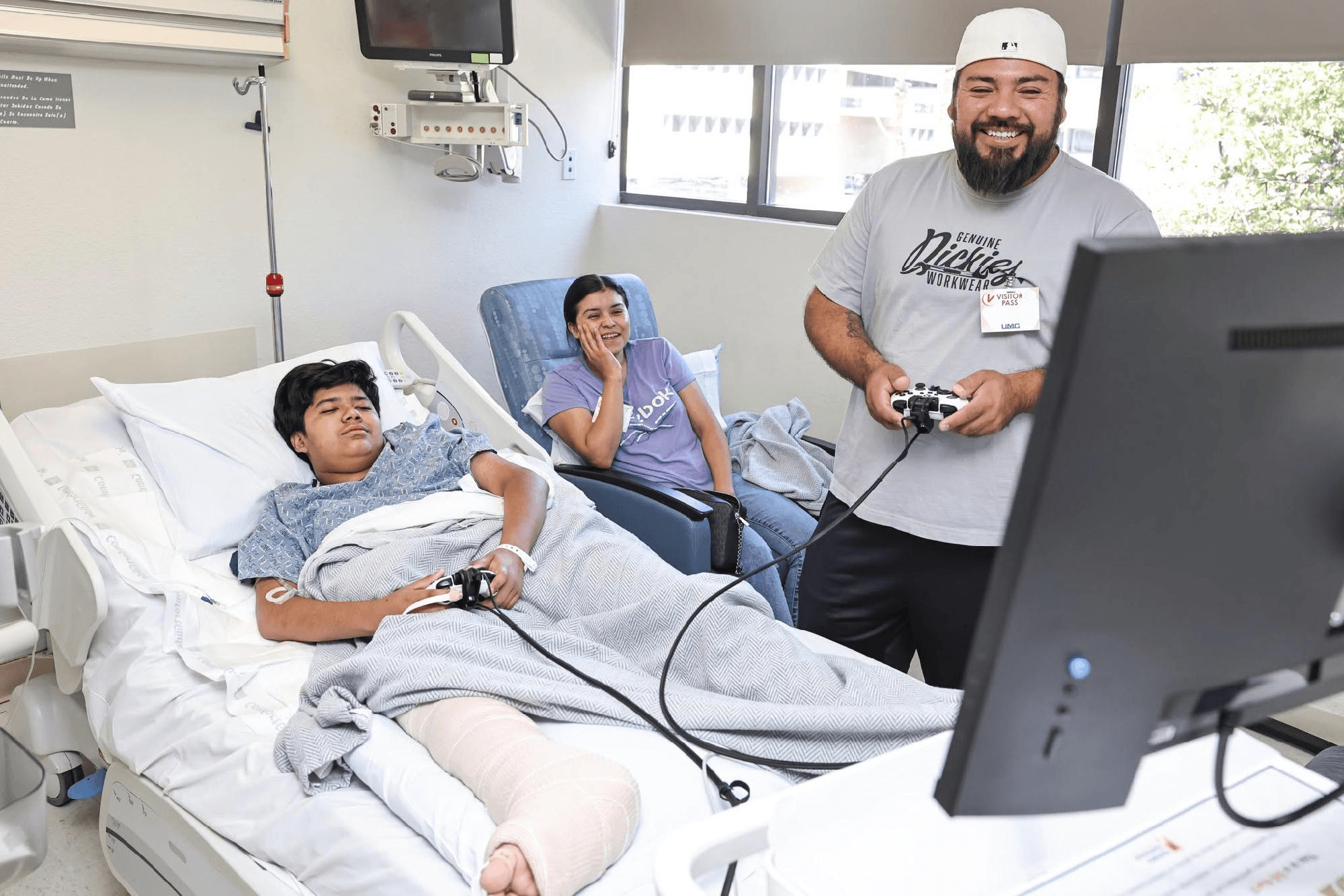 A photo of a patient playing video games with other people at a hospital.