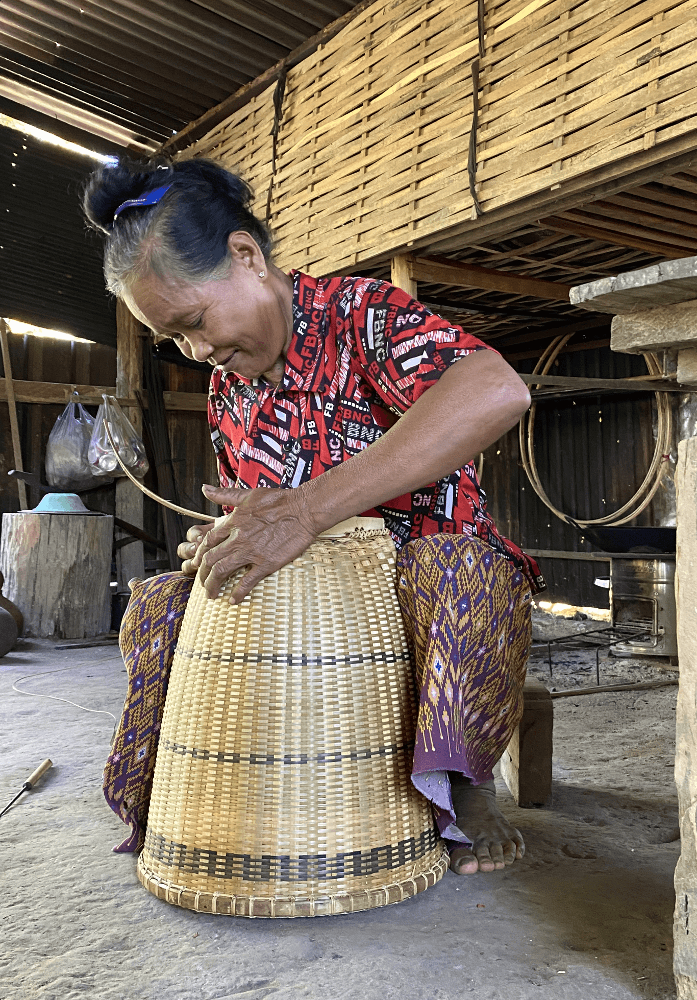 A woman weaving an indigenous basket