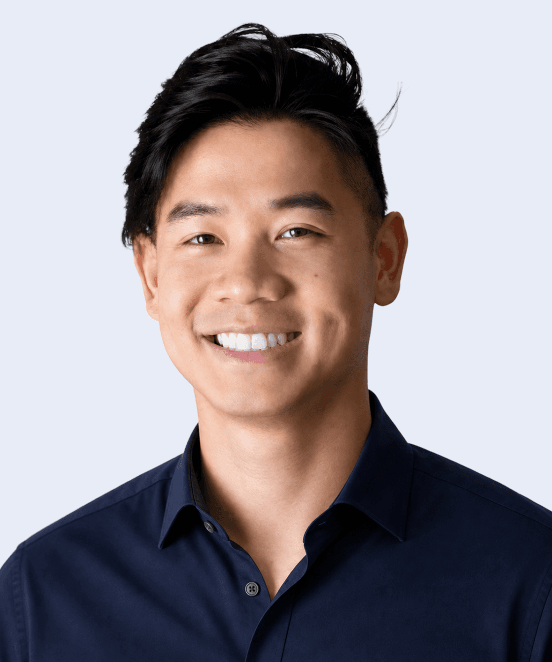 Luan Ton, Team member, smiling in a dark shirt against a light background.
