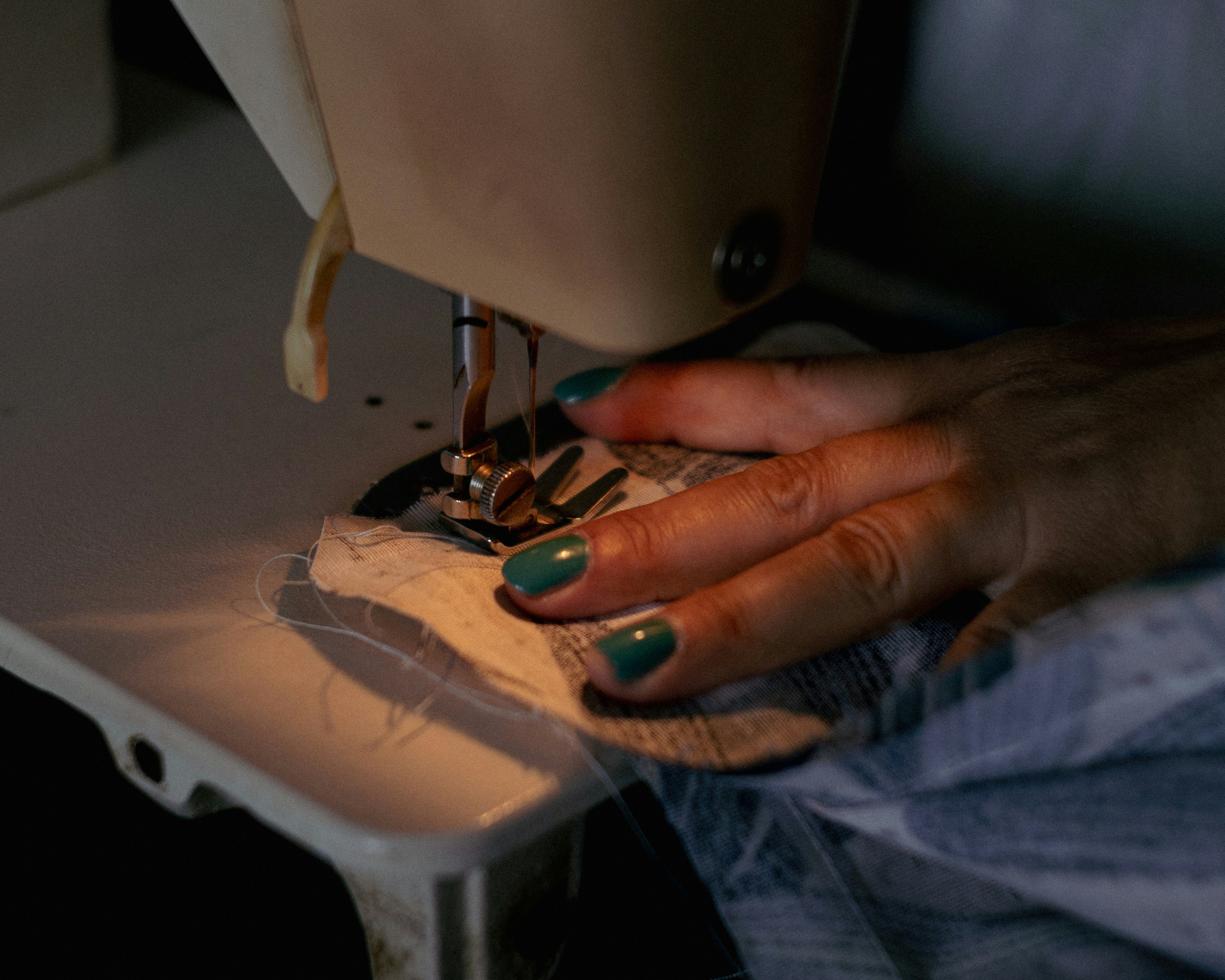 A woman using a sewing machine to sew clothes