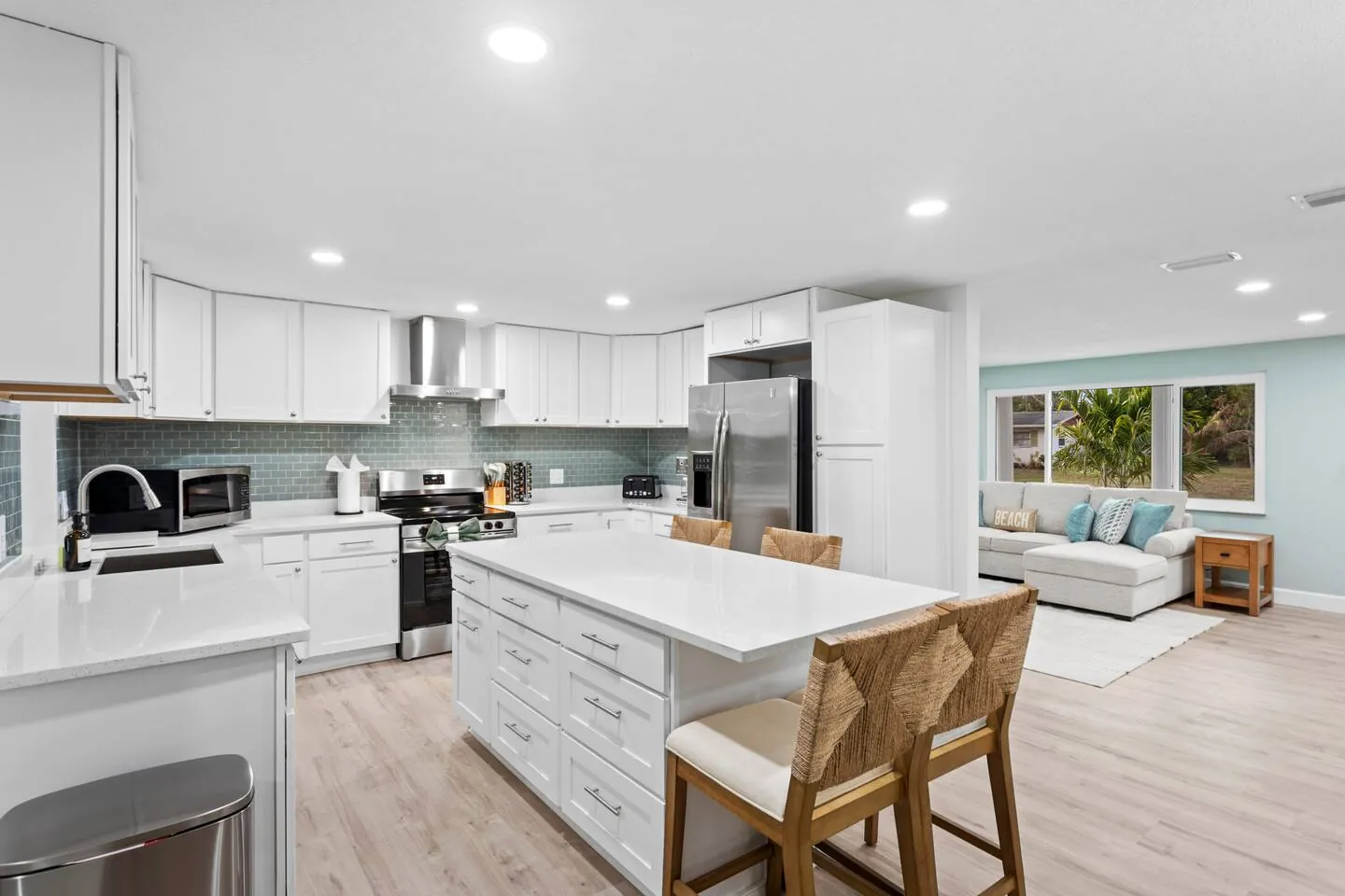 Kitchen wide with island with stools at Private Backyard Resort, Bradenton, Florida