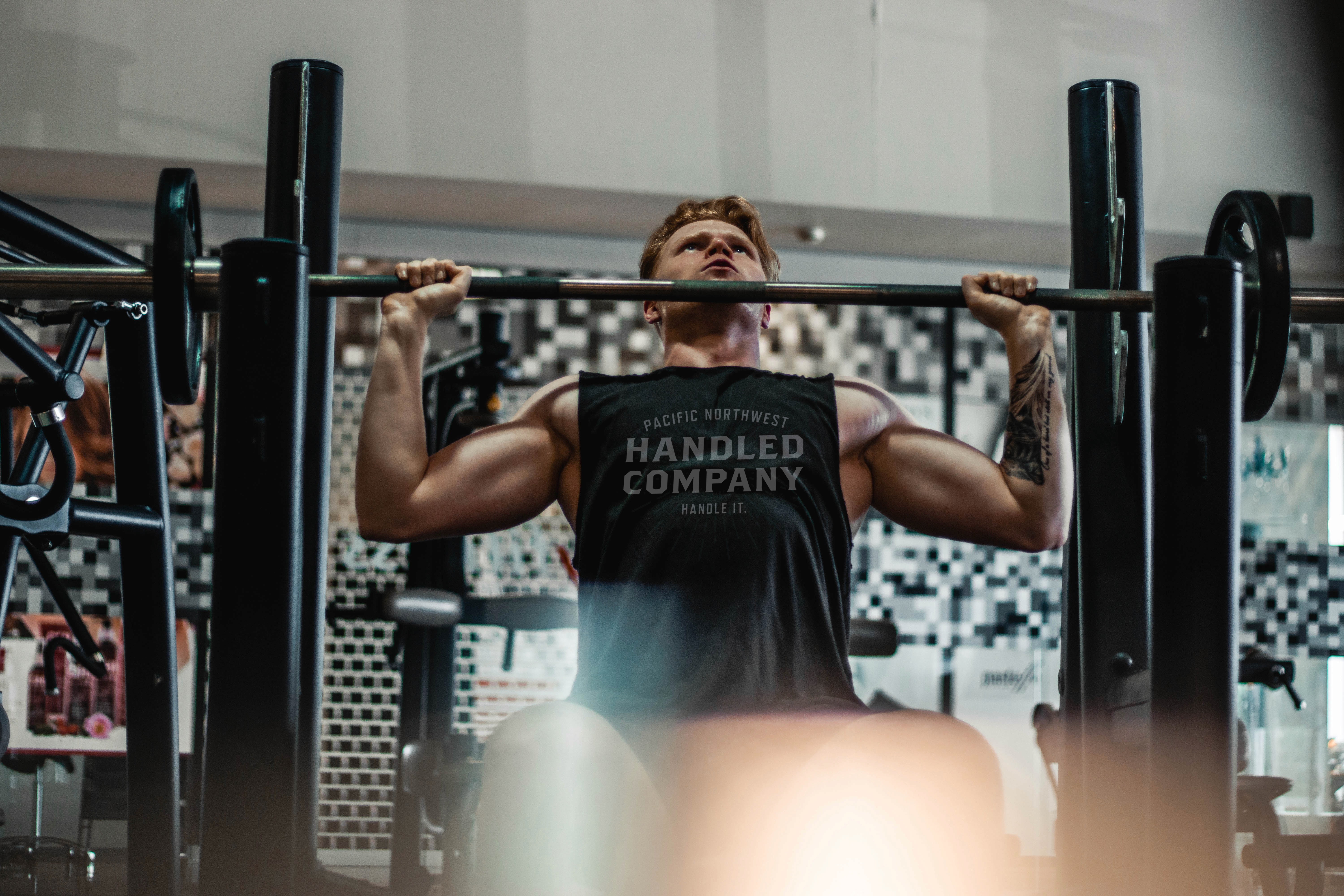 Athlete lifting barbell wearing Handled Company tank top