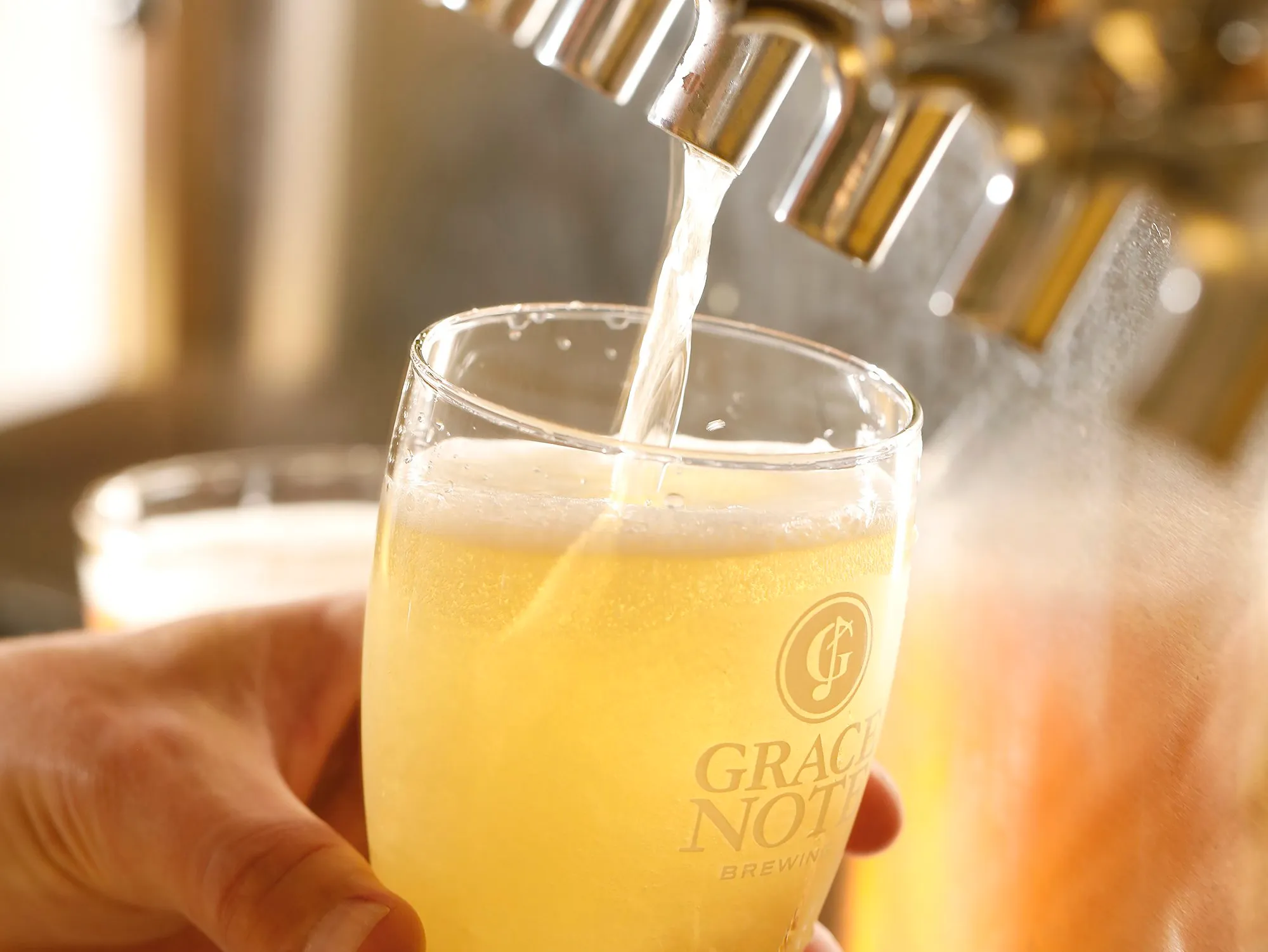 grace note brewing ale with glass and logo