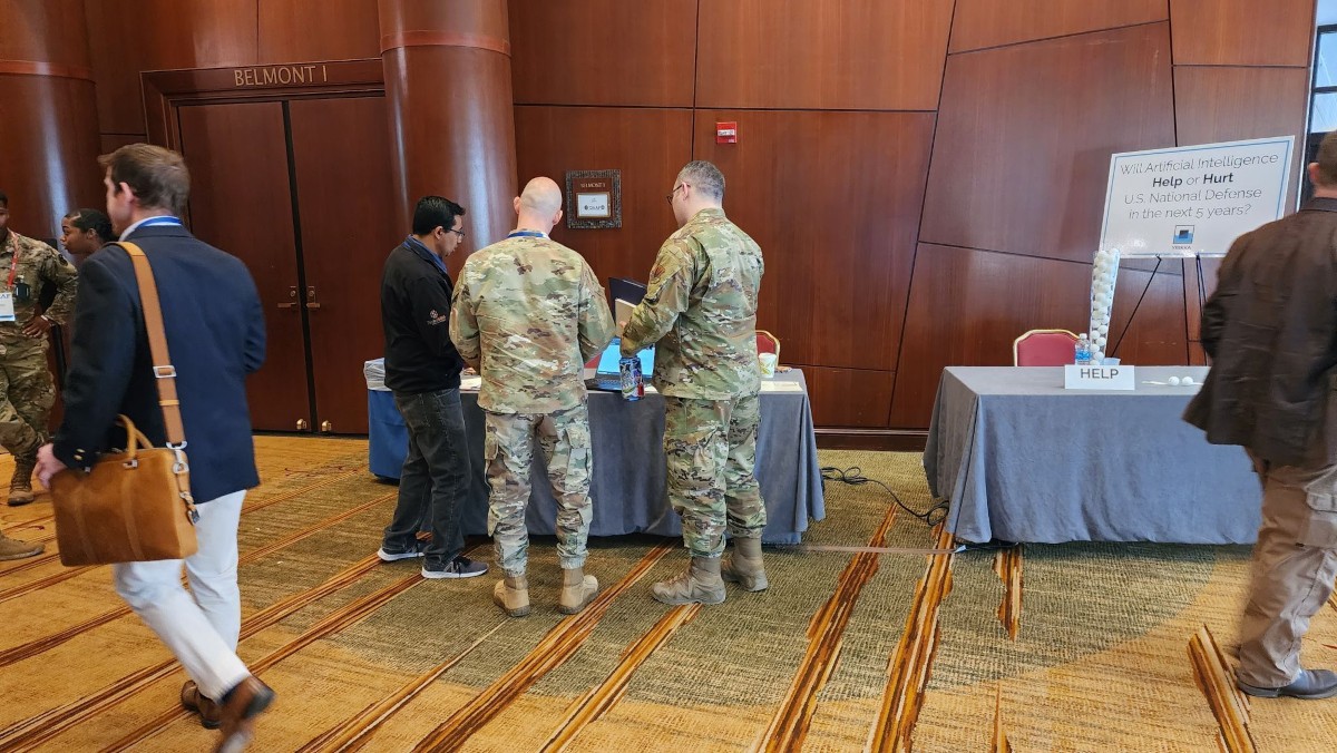 OmniSync CEO, Rupak Doshi Ph.D., speaking to two soldiers