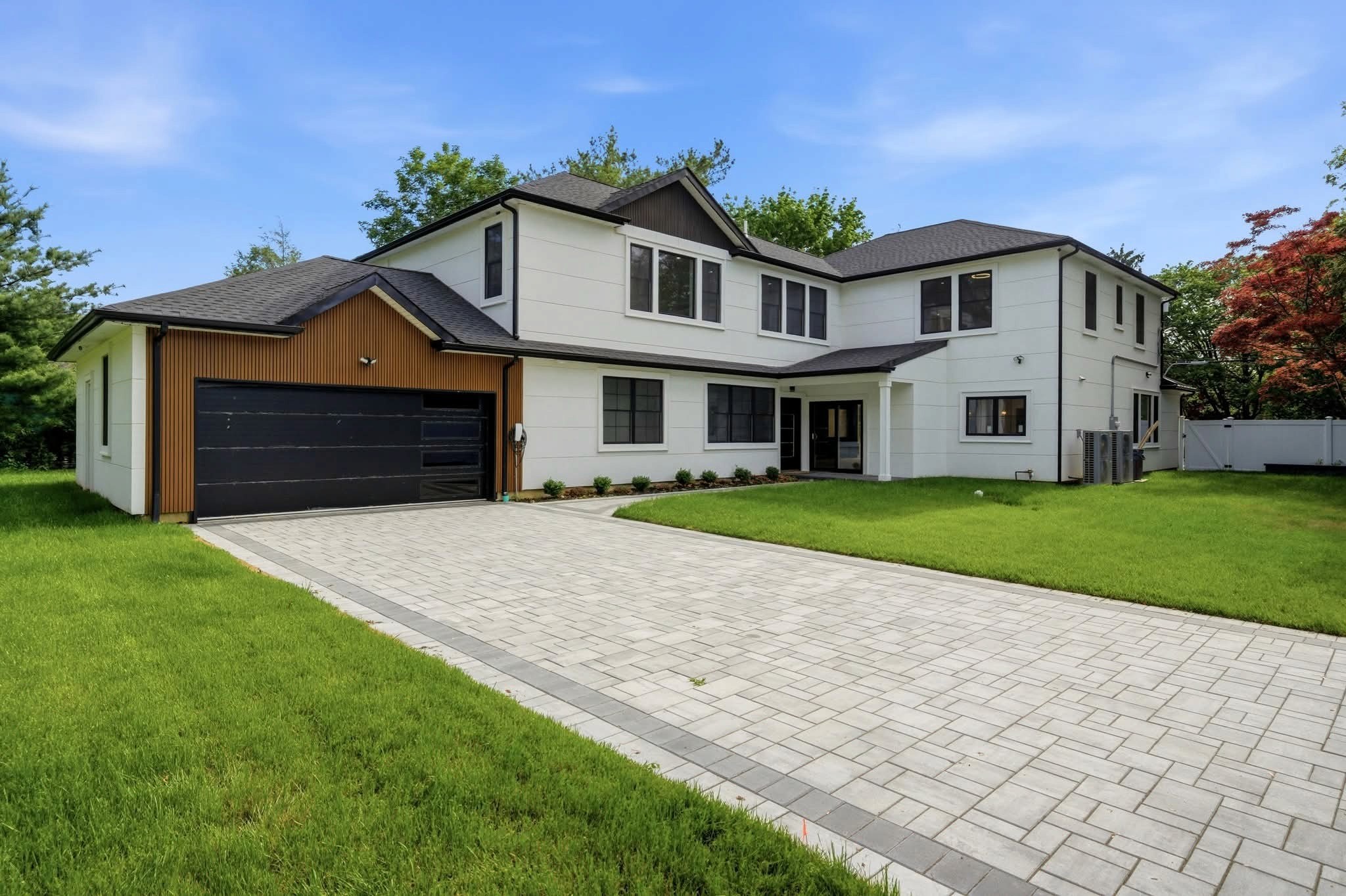Modern two-story Massachusetts home completed by Maximus Home Services with updated exterior and driveway.