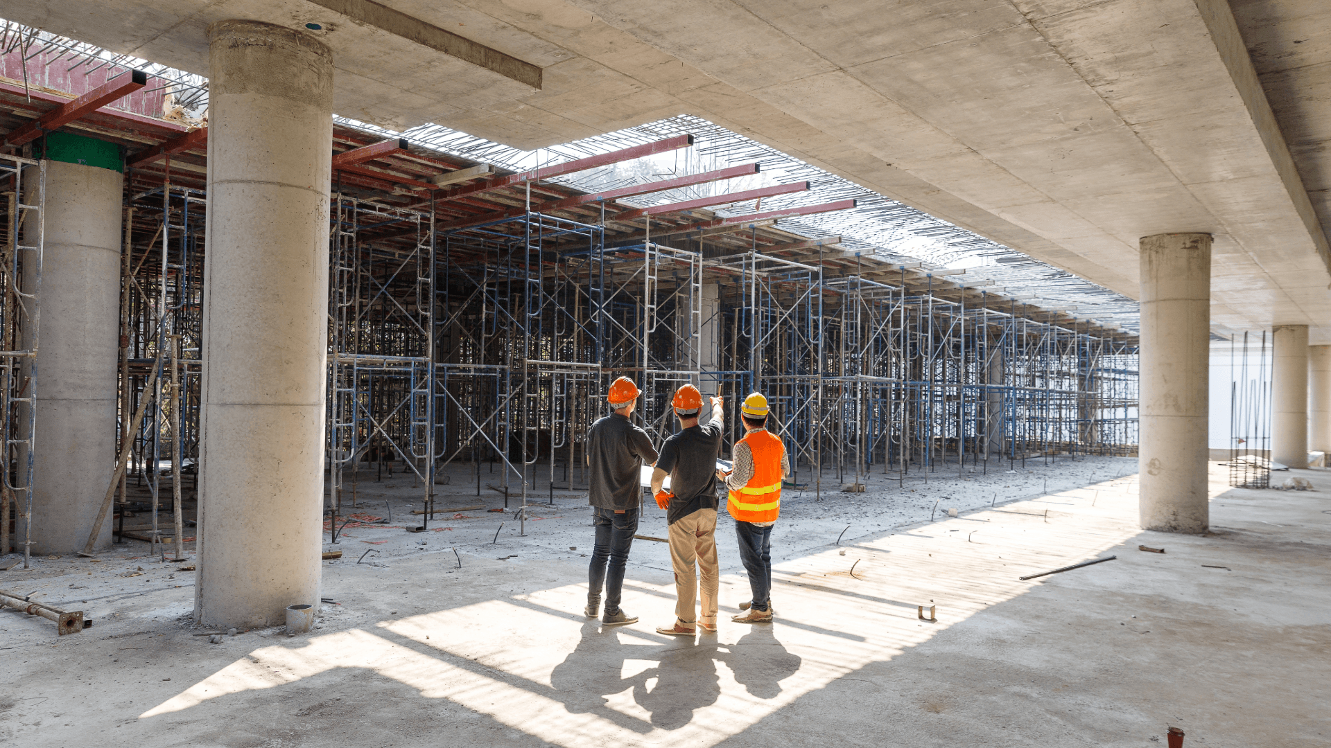 Construction professionals reviewing progress on a large UK building site, highlighting workforce planning and recruitment challenges in the construction sector.