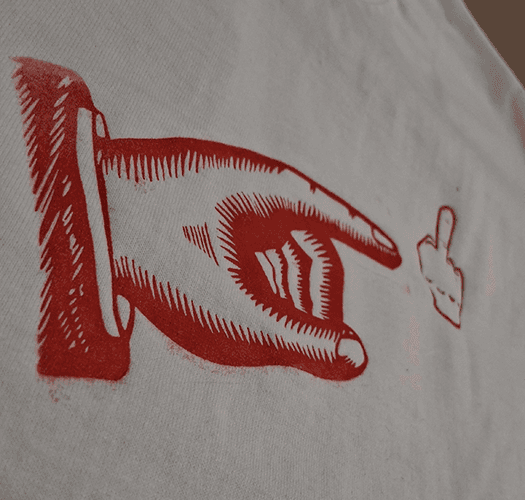 Closeup of the red symbols printed on th front of a shirt, the symbols are a small middle finger and a bigger finger pointing to the middle finger.