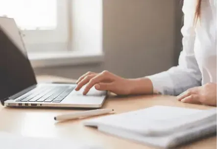Business professional using automated payment software to manage recurring customer payments.