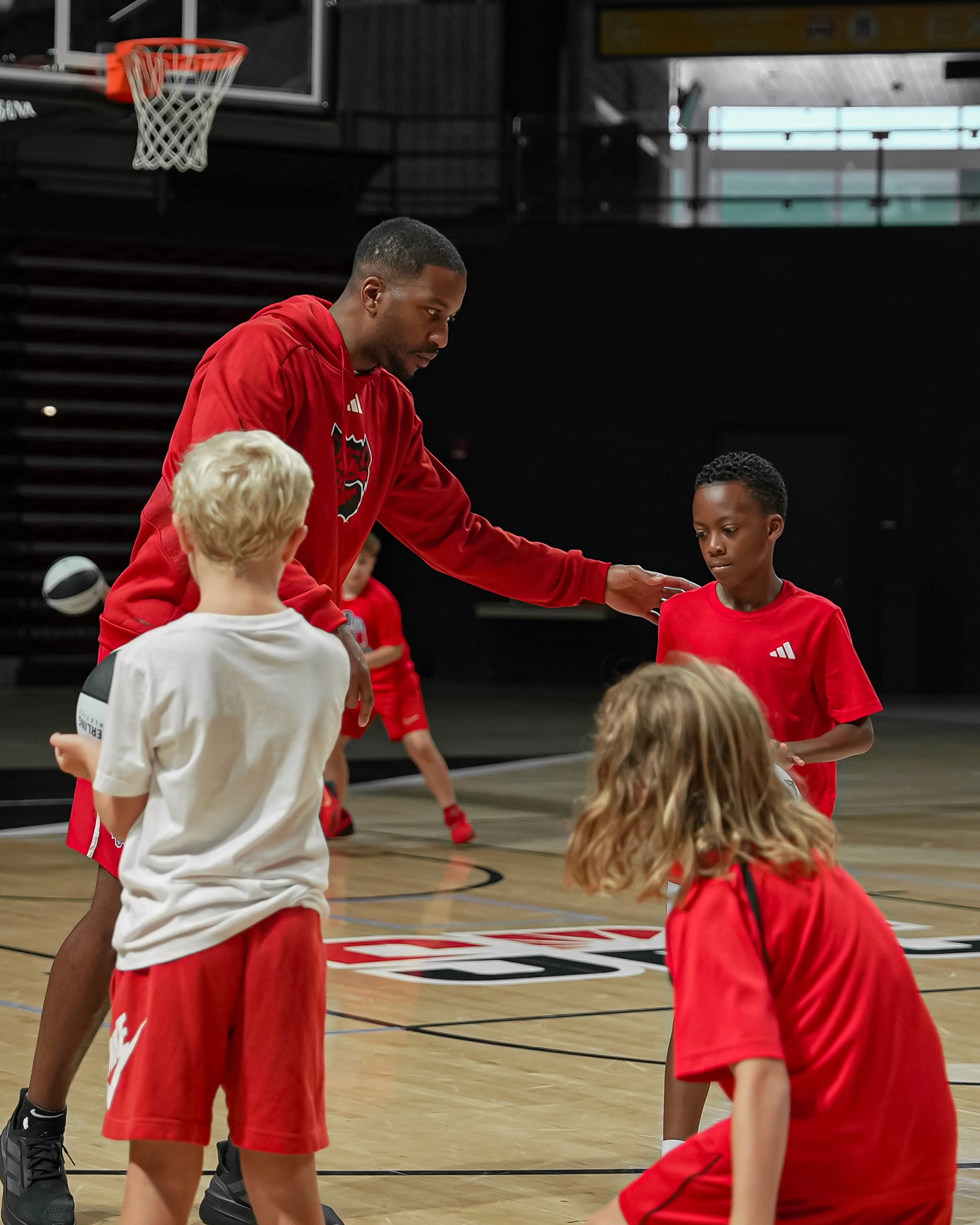 a woman sitting on a white chair next to a table