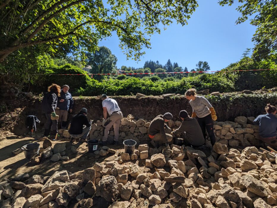 brown and white concrete house near green trees during daytime