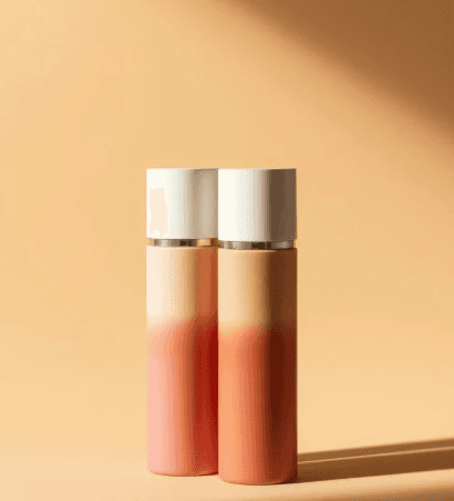 Two elegant gradient bottles with white caps stand against a warm beige backdrop. The design and soft lighting convey a sense of luxury and calm.