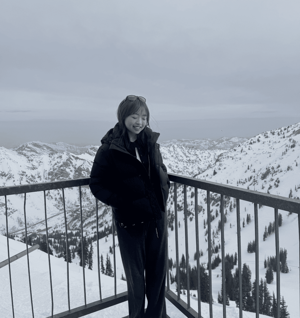 Close-up of a yellow tennis ball sitting on a green court, positioned near the white center line.