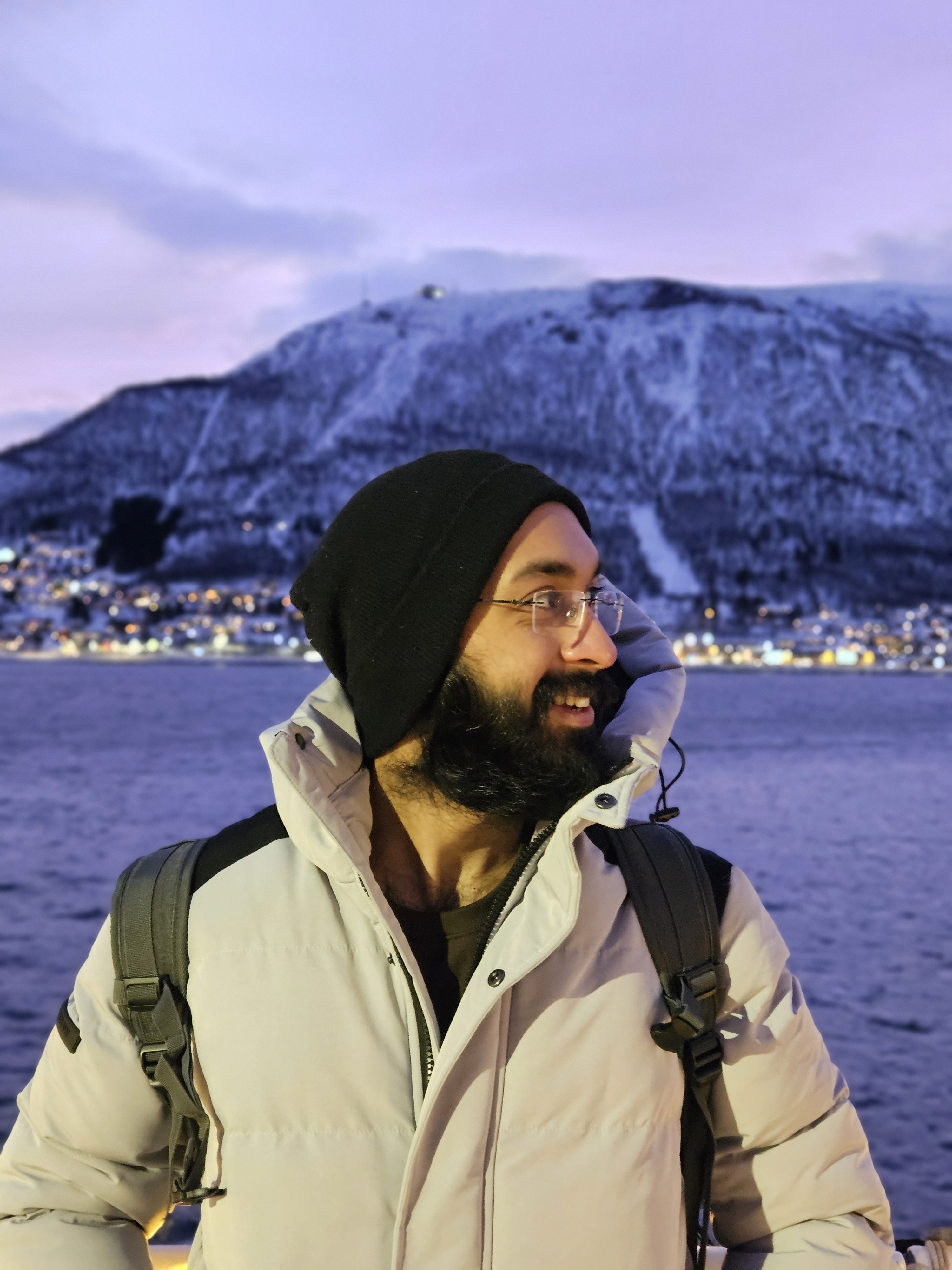 Side shot of a aman wearing a cap with the sun setting in the background