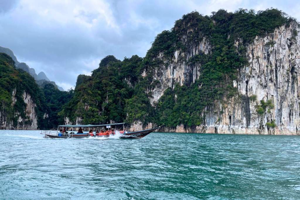 Long boat and limestone cliffs in Khao Sok, Thailand