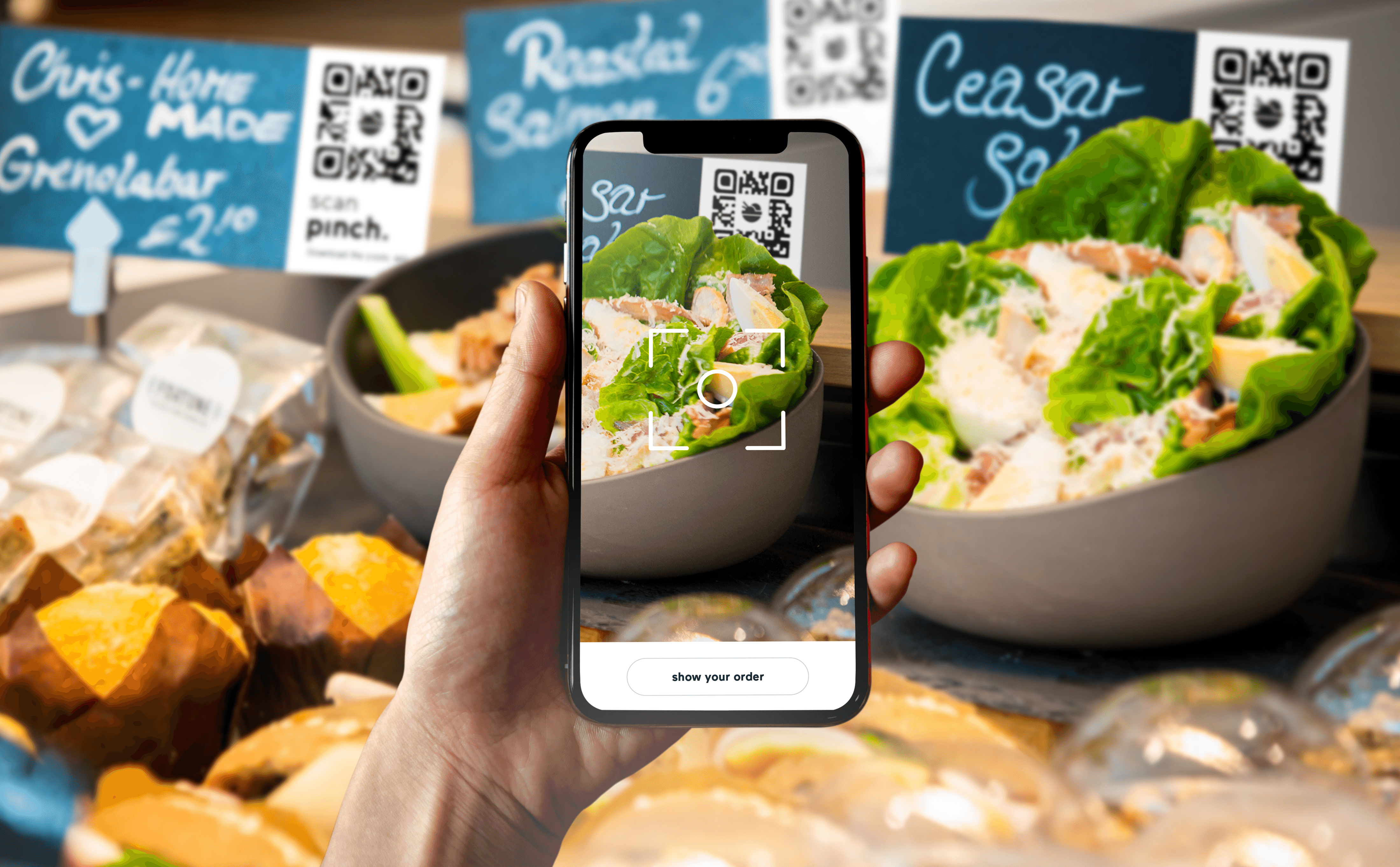 Vermaat — hand holding a smartphone scanning a QR code at a catering food counter — Soda Studio case study