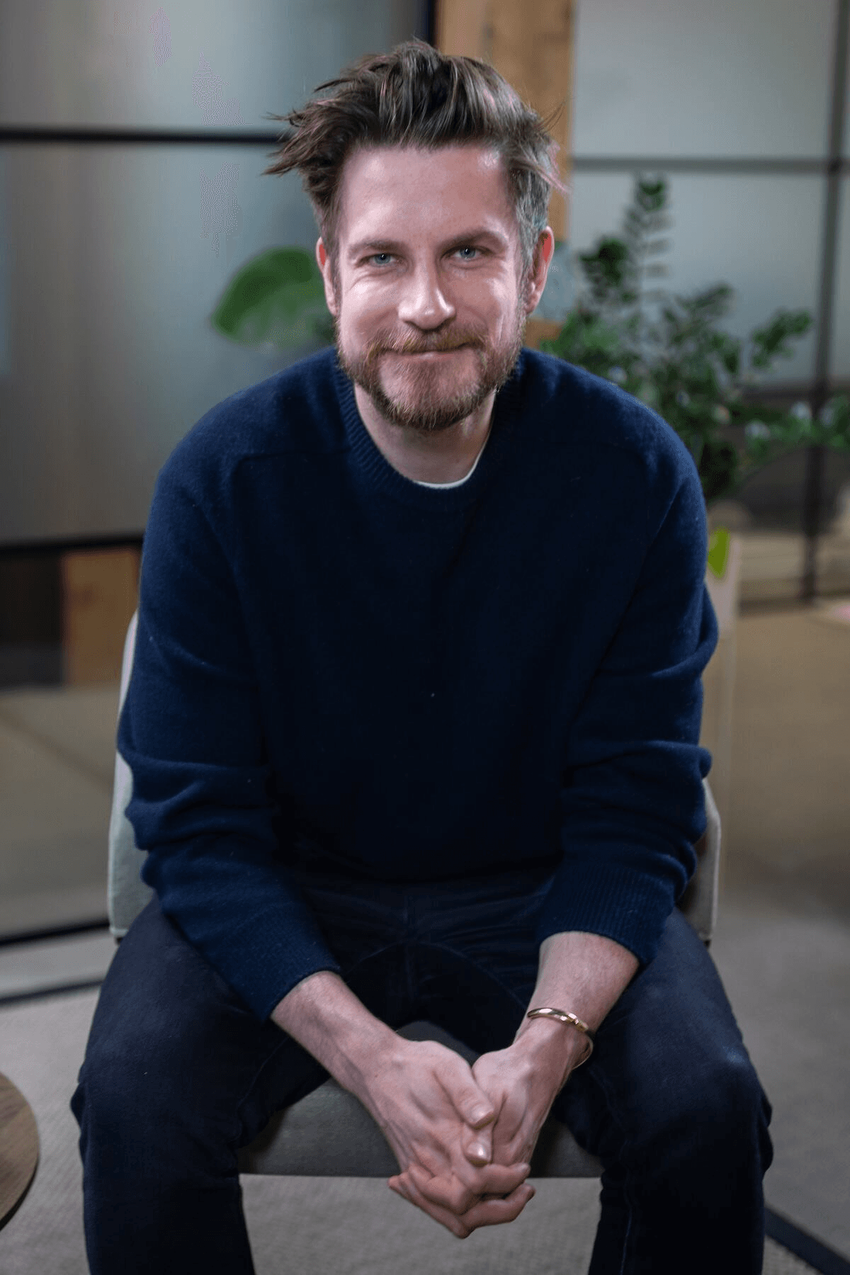 Black and white portrait of a smiling person with curly hair