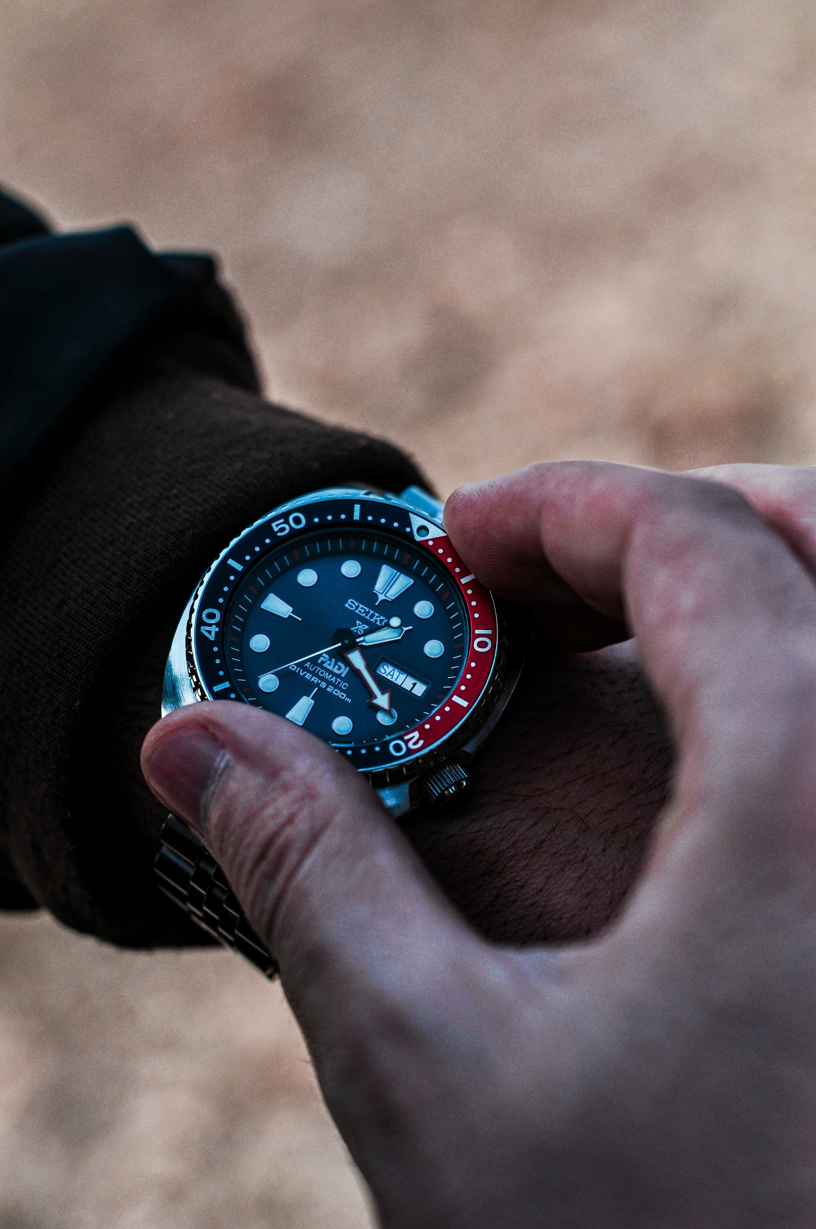 Seiko dive watch with wearer adjuting the dive bezel