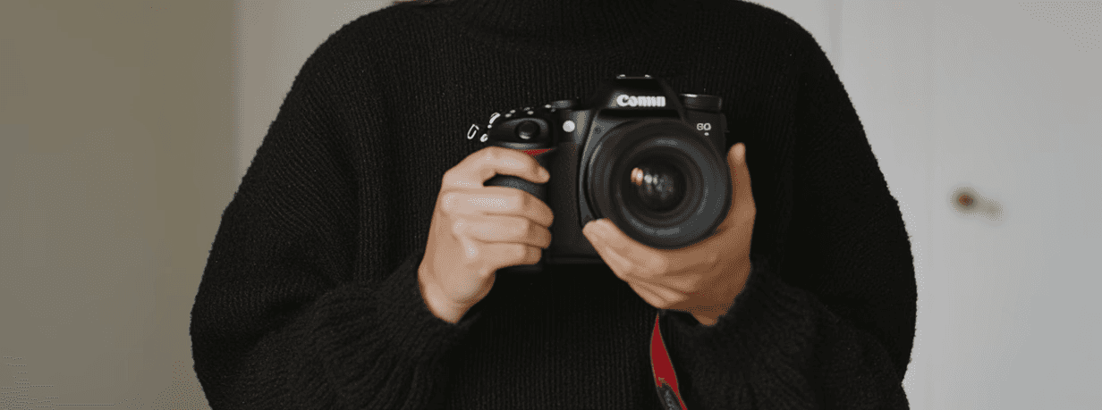 Designer holding a camera.