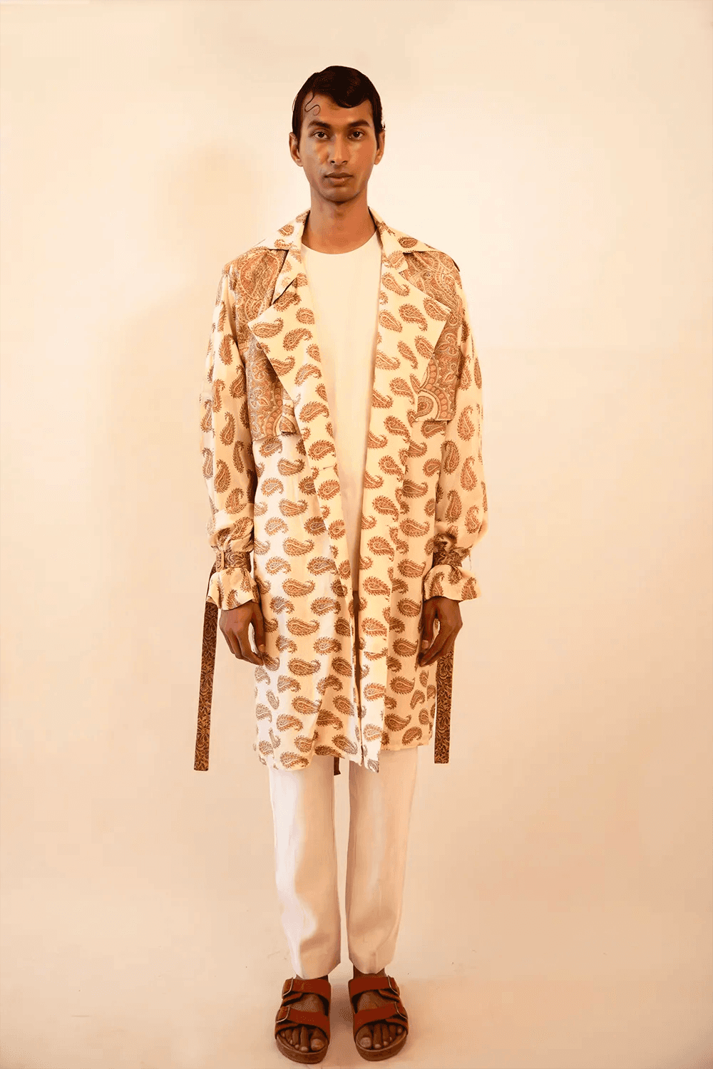 Vedya is our one-of-a-kind beige paisley silk trench coat, handcrafted by skilled artisans in-house using a vintage silk sari. 