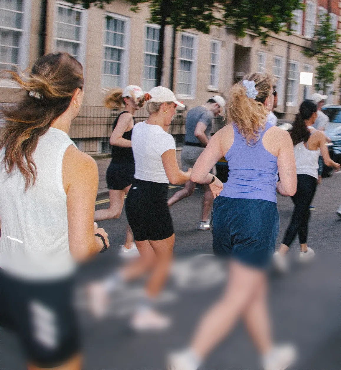 A group of women running together along a city street