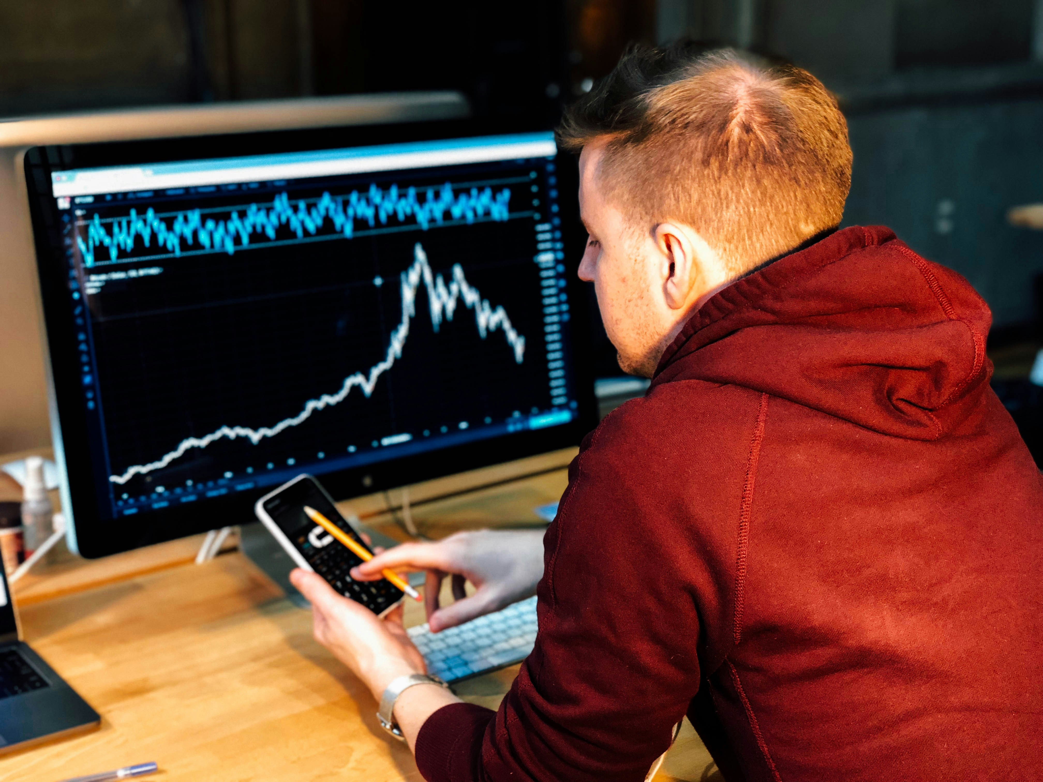 man looking at charts on screen - How Much Can You Make Trading Options